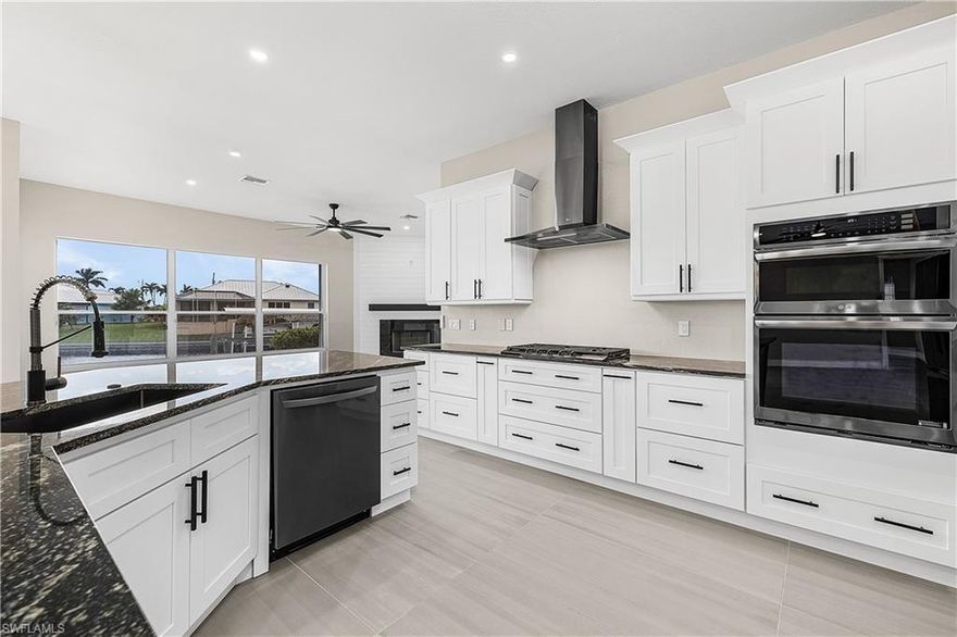 Extensively newly remodeled GULF ACCESS WATERFRONT home offers a rare blend of modern design, thoughtful upgrades, and lifestyle flexibility that stands apart from today’s repetitive new construction typical floor plans you see over and over. Featuring 3 bedrooms with one of the guest bedrooms drastically oversized, 2 bathrooms, a separate living and family room layout, and a 2 car garage. This home is designed for both everyday comfort and entertaining without having to worry about remodeling because just about everything has been recently redone. The bright open kitchen showcases custom soft close cabinetry, level 3 granite countertops, a very large non-traditional center island, new BLACK STAINLESS STEEL LG appliance package with 36 inch GAS COOKTOP and wall microwave wall oven combo with an impressive WALK IN BUTLER’s PANTRY complete with GLASS BARN DOORS, wine cooler, abundant storage, and additional countertop space. Oversized 24x48 porcelain tile flooring everywhere, recessed LED lighting, and expansive windows create a light filled interior with seamless indoor outdoor waterfront flow. The family room is anchored by a designer shiplap feature wall with gas fireplace with a striking marble look surround to be a focal point of the main living area. Both bathrooms have been fully updated with custom cabinetry, granite counters, black matt shower systems, LED mirrors, and beautifully tiled showers, while the primary suite offers a spa like retreat with a large walk in closet and shower with luxury high end elegant finishes. Major system updates include a newer roof, brand new AC system, full home re pipe, and updated lighting throughout, with SO MUCH MORE providing peace of mind for years to come. Outdoors, enjoy an OVERSIZED WATERFRONT LOT with seawall approximately 145 feet of Gulf access water frontage, a short boat ride to open water with only one bridge, and a brand new fully resurfaced pebble tech like with glass tile and newly installed stone coping solar heated pool framed by a screened lanai and amazing waterfront views. Additional highlights include a remodeled front façade, impact rated entry door, hurricane shutters, new landscaping, and transferable LOW COST FLOOD INSURANCE (approx. $1030/year). Located in a city water and sewer neighborhood surrounded by newer high value homes and a short bike ride or walk to the popular 7 ISLANDS PROJECT and local parks. Embers Pkwy is currently undergoing a “median beautification” and will have lush landscaping as you come into your wonderful neighborhood. This property delivers the space, character, and upgrades buyers want without settling for another identical floor plan, making it an ideal full time residence or luxury seasonal retreat. Please ask to see the full “Upgraded Feature List”.  Buy this unique one of a kind home now before someone else does!