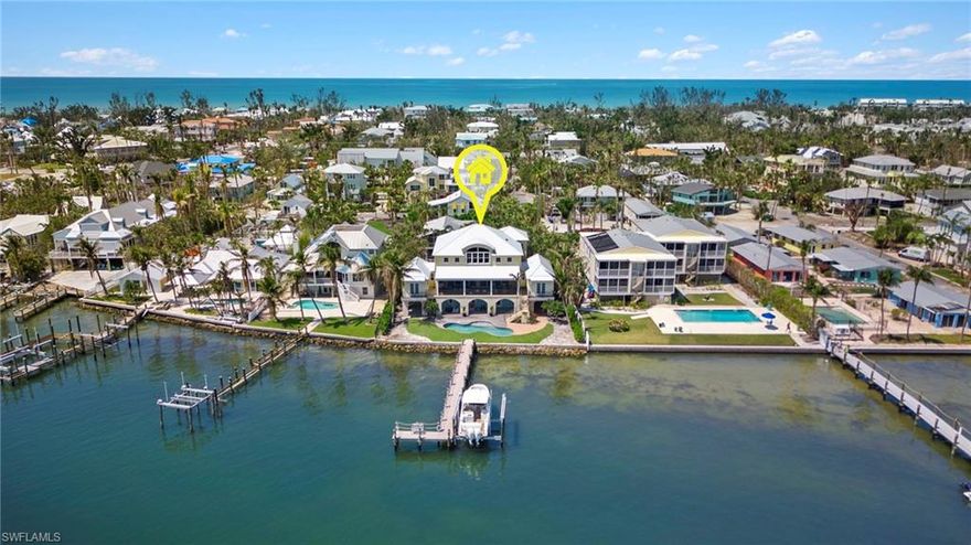 Spectacular, direct Bay-front "Yellow Bird" property is a rare find on Captiva island.  This house has breathtaking panoramic views of Pine Island Sound & Bay, heated pool, dock w/25k lb. lift built to new code, beautiful wood ceilings, generator & water filtration system. Offering 2 bedrooms and 3.5 baths, den, 3-stop private elevator, impact windows & doors, gourmet kitchen w/Wolf appliances, Sub-Zero refrigerator & freezer, formal dining, breakfast nook, hard wood & tile floors, custom built-ins throughout, lanai w/outdoor kitchen, 2-car garage and workshop area. Top floor, primary suite w/large sitting area, office, laundry room and 2 walk-in closets. Spacious primary bathroom has walk in shower, soaking tub, bidet & double vanities. This property is being sold furnished. Just a short stroll to Captiva's Village, the Gulf of Mexico, great island shopping and restaurants.