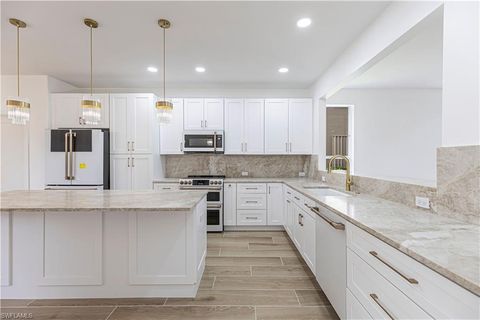 Photo of 9217 Troon Lakes DR, NAPLES, FL 34109 (MLS # 225061062)