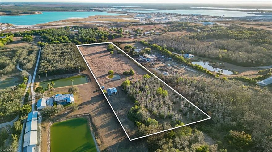 Rare opportunity to own a private 10-acre AG-2 zoned estate parcel in one of Southwest Florida’s fastest-growing corridors. Thoughtfully cleared with a preserved natural buffer for privacy, this property offers a peaceful rural setting just minutes from Alico Road, Gulf Coast Town Center, RSW Airport, and major growth corridors.
Already improved with a 40x40 barn with 14×40 workshop, well, electricity, fill dirt, and high-and-dry build areas, the land is ready for a wide range of agricultural and rural lifestyle uses allowed under AG-2 zoning. Envision a private equestrian estate, boutique farm, homestead, or a unique destination property with space for outdoor gatherings and events (subject to county approvals and permitting). The open pasture, mature trees, and tranquil pond create a natural backdrop ideal for those seeking privacy, flexibility, and long-term upside in a tightening acreage market. Whether building a custom residence, creating a small ranch, or exploring creative agri-tourism concepts, this property delivers both functionality and future potential. Opportunities for turnkey acreage with existing infrastructure are becoming increasingly rare, secure your piece of Southwest Florida land while inventory remains limited.