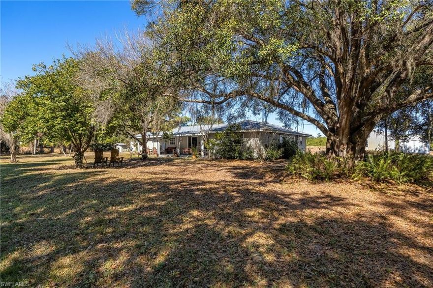 Take a Step back into the tranquil sounds and feeling of Old Florida. Situated far away from highways you will instantly feel at ease being surrounded by cow pastures, wooded area and open land. Enjoy an expansive front porch as you watch the deer and turkey passing through the beautiful oak hammock in the front yard. Step inside to a spacious living room with updated flooring and plenty of windows to allow natural lighting to light your way. The functional country kitchen allows for plenty of room for preparing meals for large gatherings. A small breakfast area and dining room are both relaxing allowing for you to enjoy your mealtime together. Three bedrooms and 2 baths make this for a great family home. Behind the living room you will find a den, TV room, game room or The Man Cave,  perfect for any size family. Outdoors is a large 30 x 40 steel barn with electricity. There is also an open carport on the back side of the barn measuring another 15' out. A small teds shed in included equipped with electric. A 4" well was installed in 2018, The AC unit manufacture date is 2022. The metal roof is 20 to 30 years old. This home is located "On The Ridge" in Felda, No need for Flood Insurance! This home on Acreage in Felda is a rare find, Schedule your showing today!