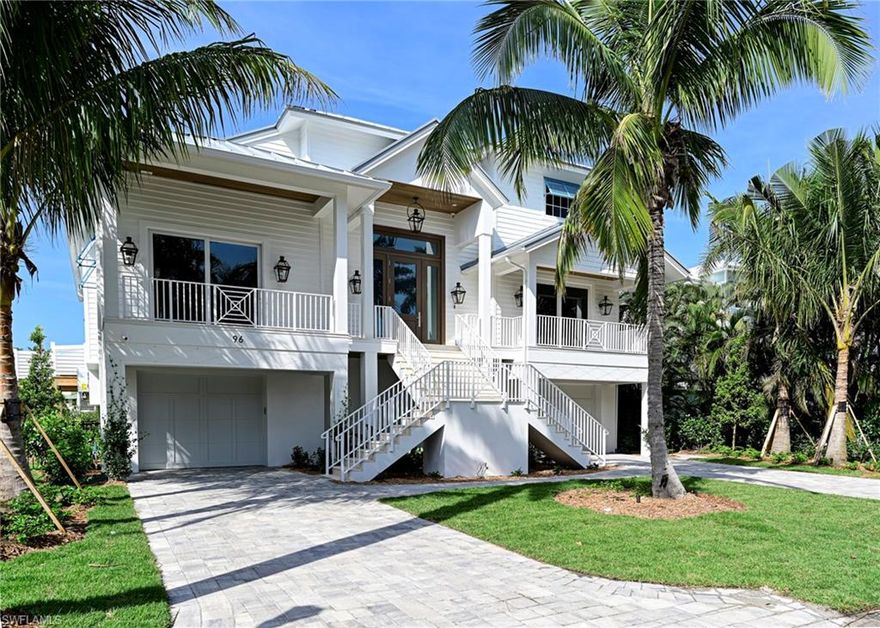 This 3 story Barefoot Beach home sits on one of the most desirable Southport on the Bay waterfront lots offering the shortest walk to the beach through the dedicated beach access, long west and south bay views plus views of the Gulf of Mexico from the main floor and 3rd floor rooms and decks. If you are a boater this home offers the ultimate dock that will accommodate a 40’ boat with lift plus another small boat or jet skis lift and even kayaks on the shore side and no bridges to the Gulf. This home was completely gutted to its shell (1999), reimagined to a 2024 floor plan and design and is Co’d in 2024, reconstructed to 2024 codes including all new, electrical, one touch lighting, plumbing, air conditioning, hot water heaters, impact windows & doors, impact garage doors, strapping, stucco including stucco siding, exterior trim, 10’ Smart Glass front door with 5 glass panels that auto frost for privacy, Gas front lights, standing seam metal roof including secondary water resistance, pool with 3 fire bowls, elevated spa including equipment, heater and deck, new exterior railings, exterior stairs, tile flooring, brick pavered driveway, all new landscaping, palm trees, sod and a whole house generator.   The interior is finished to the highest level in a light coastal design featuring 4 bedrooms 4 1/2 baths and a large open floor plan enhanced by the high volume ceilings throughout but especially in the two story wood beamed great room. There are beautiful wood accents everywhere including shiplap walls, other accent walls and ceilings including the interior of the private elevator.  Hardwood floors, custom one of a kind interior railings, all new light fixtures & plumbing fixtures, solid doors and Emtek hardware.  Kitchen offers Wolf gas range, Subzero refrigerator and freezer, microwave drawer, wine cooler, dishwasher, solid wood cabinetry, quartz countertops, brick backsplash, an oversized eat at island,  walk up bar with beverage refrigerator & sink. The large covered lanai has wide water views over the pool and includes electric screens, tongue and groove wood ceilings, gas grill with hood, sink, and large tv. All 3 Guest rooms are on the main living level with en-suite baths & king size beds finished with outstanding details plus convenient laundry and half bath. The master sits by itself on the upper living level offering the ultimate private retreat, stunning water & gulf views from the bed & open deck for private sunbathing and sunsets. The mater bath includes a shower with rain head left and right wall massaging jets and hand held faucet, a free standing tub centered on the window, his and hers separate sink areas plus vanity, a morning bar, laundry & custom closet. The covered lower lanai off the pool features a gray stone fireplace with large screen above. A 4 car garage and large lower level (finished to code). This property is offered furnished move in ready.  Southport on the Bay is a double gated community with 24 hour guard patrols.
