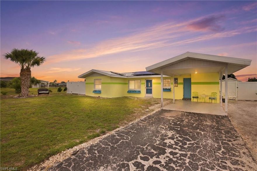 Welcome to this charming 3-bedroom, 2-bath waterfront pool home in the heart of Port Charlotte!  Enjoy peace of mind with numerous recent updates, including a new metal roof (2023), photovoltaic solar system with Tesla Powerwall (2023), and A/C system (2021). Offering 1,304 square feet of living space, the home also features a spacious, fully fenced backyard.  The true centerpiece is the stunning waterfront setting. Expansive canal views and thoughtfully designed outdoor living spaces create the ultimate Florida lifestyle. A large deck spans the water’s edge, ideal for entertaining, dining, or simply unwinding while taking in the serene surroundings. Multiple seating areas and a manicured lawn lead seamlessly to the dock, making it perfect for boating, kayaking, fishing, or relaxing by the water. A screened waterfront gazebo with a metal roof elevates the experience, complete with a hammock, lounge seating, ceiling fan, and mounted TV—your own private retreat. Boating enthusiasts will appreciate approximately 80 feet of seawall and a wide canal with just one bridge to Charlotte Harbor, offering access to the Gulf of Mexico. Inside, the home features an open-concept living and dining area with neutral finishes and a clean coastal aesthetic. Large windows and sliding glass doors flood the space with natural light and open seamlessly to the screened pool and lanai, creating effortless indoor-outdoor living. Designed for year-round enjoyment, the pool area offers generous deck space for lounging and entertaining, all protected by a white aluminum screen enclosure, along with a covered seating and dining area for added comfort. Durable, multi-tone wood-look tile flooring runs throughout—no carpet. The updated kitchen showcases white raised-panel cabinetry w/ crown molding, granite countertops w/ a full-height matching backsplash, and a suite of new stainless-steel appliances. A barn-style interior door adds character to the primary suite. The primary suite offers direct access to the lanai and pool, along with an updated en-suite bath featuring a tiled walk-in shower with pebble flooring and a single-sink vanity. Two additional bedrooms share an updated guest bathroom with a freestanding clawfoot tub and a granite-topped vanity with a striking blue glass vessel sink. Step outside to a turfed side yard featuring a jasmine-covered outdoor shower. Additional highlights include a covered carport, cozy fire pit area, and an 8x12 utility shed. This waterfront property would make an excellent vacation rental or a relaxing weekend getaway. Ideally located in a desirable area of Port Charlotte, you’ll enjoy convenient access to Charlotte Harbor Beach Park and boat launch, as well as being just minutes from downtown Punta Gorda, Ponce de Leon Park, Fishermen’s Village, and all the shopping and dining along US-41. Some of Southwest Florida’s most beautiful Gulf beaches—including Englewood Beach, Manasota Key, Venice Beach—are just a short drive away.