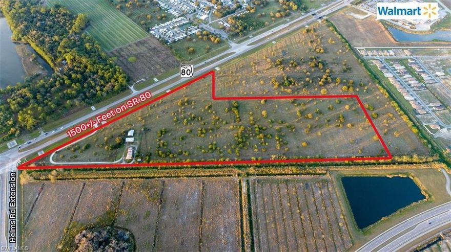 PRIME HIGH VISIBILITY 30 AC. COMMERCIAL SITE! Prime 30+/- acre development site with approximately 1,500+/- feet of frontage on State Road 80, located at the signalized intersection of SR 80 and Helms Extension Road in LaBelle, Florida. This highly visible site lies along the community’s primary four-lane commercial corridor and is situated just feet from Walmart, Tractor Supply, and O’Reilly Auto Parts, with planned development for the new LaBelle High School, a car dealership, car wash, hotel, and fast-food restaurant nearby.

LaBelle serves as a key crossroads community, positioned at the intersection of SR 80 and SR 29, providing direct access across Southwest Florida. The location offers convenient connectivity to both the east and west coasts of Florida, with Miami approximately 2½ hours away and Orlando approximately 3 hours away, making it an attractive hub for commuters, logistics, and regional commerce.

Once a rural market, LaBelle has evolved into a fast-growing bedroom community for Fort Myers, Naples, and Cape Coral. Growth is further supported by site work underway for the new LaBelle High School on Helms Extension Road, driving increased traffic, infrastructure expansion, and surrounding development.

The property is currently zoned Agricultural and benefits from an agricultural exemption, keeping holding costs exceptionally low until development. Rezoning for commercial use through Hendry County is anticipated to be straightforward, offering an excellent land-banking or phased development opportunity.

The land consists of semi-improved pasture and includes a wood-frame stilt caretaker’s residence. Utilities are currently in place to Walmart, with planned extensions to the Lee/Hendry County line, supporting future commercial development.

With its signalized intersection, extensive frontage, proximity to national retailers, low carrying costs, expanding utilities, and strategic regional access, this property represents a rare opportunity to acquire a premier commercial development site in one of Southwest Florida’s emerging growth corridors.