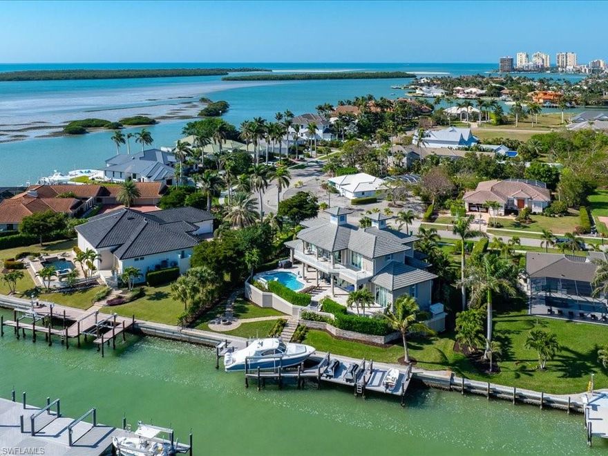 HERE IS YOUR OPPORTUNITY TO OWN A ONE OF A KIND CUSTOM HOME BUILT WITH TOP OF THE LINE FINISHES AND IS BEING OFFERED BEAUTIFULLY FURNISHED IN THE ESTATE SECTION OF MARCO ISLAND. SIT ON THE LANAI BY THE RESORT STYLE POOL AND SPA, AND SOAK IN THE SUN WITH THE BREATHTAKING VIEWS. THE WATERFRONT FEATURES A MODERN DOCK WITH 3 LIFTS INCLUDING A 24,OOO BOAT LIFT, 4,500 DOUBLE JET SKI LIFT, AND A 14 X 15 PLATFORM LIFT. THE STUNNING COVERED LANAI HAS A SUMMER KITCHEN, IMPRESSIVE FIRE PLACE, DESIGNER FURNITURE, WITH ELECTRIC SCREENS AND SHUTTERS. STEP INSIDE THE RESIDENCE TO EXPERIENCE A COASTAL DESIGN OF CASUAL ELEGANCE WITH WINDOW WALLS AS YOUR BACKDROP COMPLEMENTED WITH COFFERED CEILINGS AND HAND CRAFTED CROWN MOLDINGS. THE CHEFS DREAM KITCHEN IS ENHANCED WITH IMPORTED GRANITE COUNTERS WITH AN EXPANSIVE ISLAND, STATE OF THE ART GAS COOKTOP, AND STAINLESS APPLIANCES. THE HOME HAS 2 LUXURIOUS PRIMARY SUITES WITH HOTEL INSPIRED BATHS. THERE ARE 2 ADDITIONAL BEDROOM EN-SUITES AND 2 LAUNDRY ROOMS PLUS A POOL BATH. ADDITIONAL UPGRADES INCLUDE, WHOLE HOUSE GENERATOR, 3 AC SYSTEMS WITH 2 DEHUMIDIFIERS, 2 TANKLESS GAS WATER HEATERS, INSTANT HOT WATER CIRCULATION, 2 WET BARS AND A 400 BOTTLE WINE CABINET, SALTLESS WATER SOFTENER SYSTEM, 16.5 FEET FIRST FLOOR ELEVATION, CLIMATE CONTROLLED 4 CAR GARAGE, 3 FLOOR ELEVATOR, IMPACT GLASS AND MORE. THIS IS TRULY A MUST SEE ESTATE.