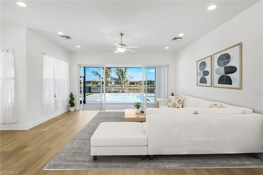 Welcome to refined, resort-style living in the prestigious 55+ community of Valencia Trails. This exceptional new construction residence blends sophisticated design with modern convenience, offering three well-appointed bedrooms, three elegant baths, and a versatile den ideal for a home office, media room, or guest retreat.

The light-filled, open-concept floor plan is designed for effortless living and entertaining. At the center of the home, the chef’s kitchen impresses with premium appliances, sleek quartz countertops, and a generous island perfect for casual dining or hosting friends. The spacious great room extends through expansive sliding glass doors to a covered lanai, revealing a private 30-foot lap pool with spa—an inviting space to unwind or stay active year-round.

The serene primary suite serves as a true retreat, complete with a spa-inspired bathroom and expansive walk-in closets. Two additional guest suites, each with a dedicated bath, ensure comfort and privacy for visitors. Throughout the home, #1 grade hardwood flooring, striking Art Deco–inspired lighting, and an epoxy-finished garage elevate both style and function. A robust 300-amp electrical system supports up to three electric vehicles, catering to today’s modern lifestyle.

Offered unfurnished and ready for your personal touch, this home is your opportunity to create a space that reflects your vision. As a Valencia Trails resident, enjoy world-class amenities including a grand clubhouse, resort and lap pools, pickleball and tennis courts, a cutting-edge fitness center, scenic walking trails, and a vibrant calendar of social events. Discover exceptional Naples living where luxury, comfort, and community converge.