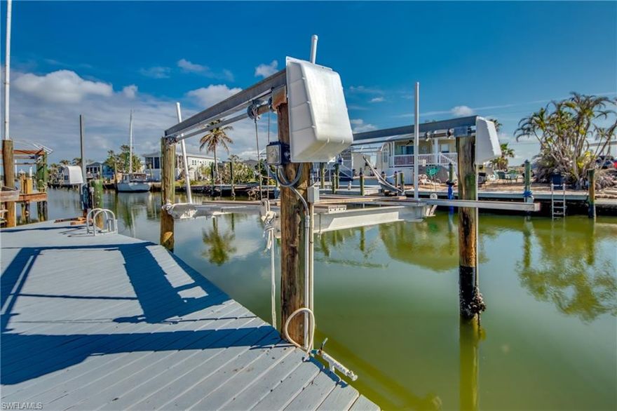 Own your piece of paradise on wide canal with direct access to the Gulf on San Carlos Island. 2 bedrooms/ 2 bathrooms waterfront canal home with Gulf access. Ideal location on San Carlos Island. Walking distance to the Beach, Doc Fords, Dixie Fish, Salty Sam's Marina, Key West Express. Your own private boat dock with electric lift and water at the walkout dock. Attached 2 car garage is very rare and you will love it.  Lots of storge in garage attic with pull down ladder. Home offers a modern open living area with skylight and a dedicated dining area. Laundry in residence.  Large, enclosed Florida room great for entertaining and relaxing looking over the canal.   Just minutes to the Gulf with direct access.  Get a golf cart and love living on this Island.