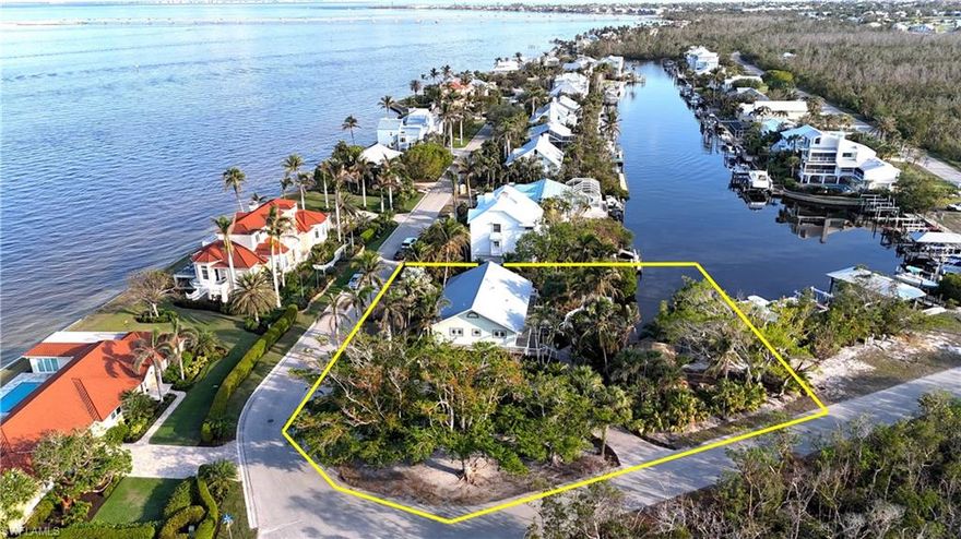 Your search is over! STOP SCROLLING! All reasonable offers will be entertained. Welcome to 1307 Isabel Drive, an extraordinary island oasis located on the serene bay side of beautiful Sanibel Island. This 3-bedroom, 3.5-bathroom home offers the ultimate waterfront lifestyle, with every room boasting breathtaking water views. Situated at the end of a canal, the property features two docks, including a 10-ton boat lift, making it a true boater's paradise. Built with love and craftsmanship since 1991, this home was completely renovated in 2005. The house was transformed into a hurricane-proof haven with reinforced walls, PGT impact windows, and a sturdy metal roof capable of withstanding winds over 200mph. The wraparound deck, measuring 2,150 square feet, provides ample space for outdoor entertaining and overlooks the lush, tropical landscape and canal. The main living area spans 1,750 square feet and features vaulted ceilings, beautiful solid birch floors, and custom 1x6 cypress wood throughout. The gourmet kitchen is a chef’s dream, equipped with granite countertops, a gas range, wine cooler, and ample dining space for 10-12 guests. The living area flows seamlessly into a music room, offering a perfect spot to relax and entertain. The spacious master suite boasts a large walk-in closet, a spa-like bath with double granite vanities, a stone shower, soaking tub, and bidet. A standout feature of the property is the private 755-square-foot guest cottage, which offers a full gourmet kitchen, large bedroom and bathroom, and a spacious living area. The cottage opens to a 645-square-foot lanai and a 30'x15' pool, ideal for extended outdoor dining and relaxation. The tropical yard, with its royal palms, coconut trees, birds of paradise, and traveler’s palms, offers complete privacy and creates an idyllic setting for outdoor living. At the end of the canal, a 12'x18' chickee hut, built by O.B. Osceola of the Seminole Tribe, provides a magical retreat. The lush, mature foliage of this property is truly unmatched on Sanibel Island. Additional amenities include a large two-car garage, climate-controlled storage/workshop space, a newly renovated irrigation system, and a buried propane tank that can power a whole-house generator. For boaters, the property features two docks, multiple davit bases, and easy access to the bay. This home offers unparalleled privacy, a spacious lot, mature tropical landscaping, and the rare combination of a fully separate guest cottage and extensive boating facilities. This is a once-in-a-lifetime opportunity to own a piece of paradise on Sanibel Island.