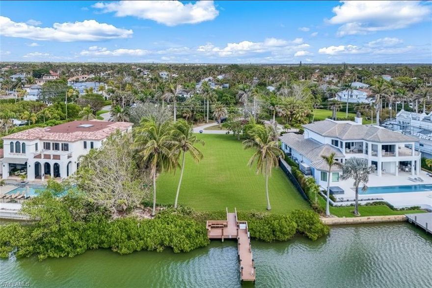One or more photo(s) has been virtually staged, AI generated or rendered.  Currently the largest gulf-access available lot in the Moorings, 286 Spring Line Drive has 122 feet of water frontage with an over 300-foot southwestern view of Hurricane Harbor. This almost half-acre lot offers endless possibilities.  Enjoy an easy, 5-minute boat ride to the Gulf through Doctor's Pass.  Spring Line Drive is a secluded, low-traffic street, perfectly positioned in the Moorings and conveniently located to all of downtown Naples.  Only a short walk away, the Moorings Beach Park, a private beachfront retreat featuring pristine white sands and calm Gulf waters without the crowds of public beaches, is available through membership of the Moorings Property Owners Association. A recently rebuilt dock and a new 13,000 lb boat lift are situated within mature mangroves on the bayside property line, which provides some of the clearest and cleanest waters, and the best fishing, in the bay right off your dock.  Seller financing will be considered.