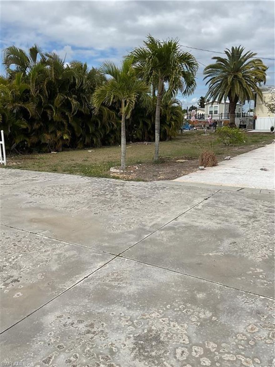 Build your ideal Pine Island retreat on this oversized 80x90 cleared lot located on quiet Flamingo Drive in Saint James City. This property is ready for your new manufactured home or a single-family home. There are no impact fees if you replace it with a manufactured home, there is a existing septic system and a wide-open building footprint. Enjoy direct water access from your private fingerling dock positioned with in the 10ft easement complete with a deeded concrete driveway. The lot sits high and open offering easy buildability and ample space for parking, outdoor living and storage. The HOA is voluntary that includes use of the pool & boat ramp if you chose to join. It is close to marinas, waterfront dining and all the charm of Pine Island living. This homesite offers exceptional value for a seasonal get away or full time Florida lifestyle. Just minutes out to great fishing or visiting the Cayo Costa beach.