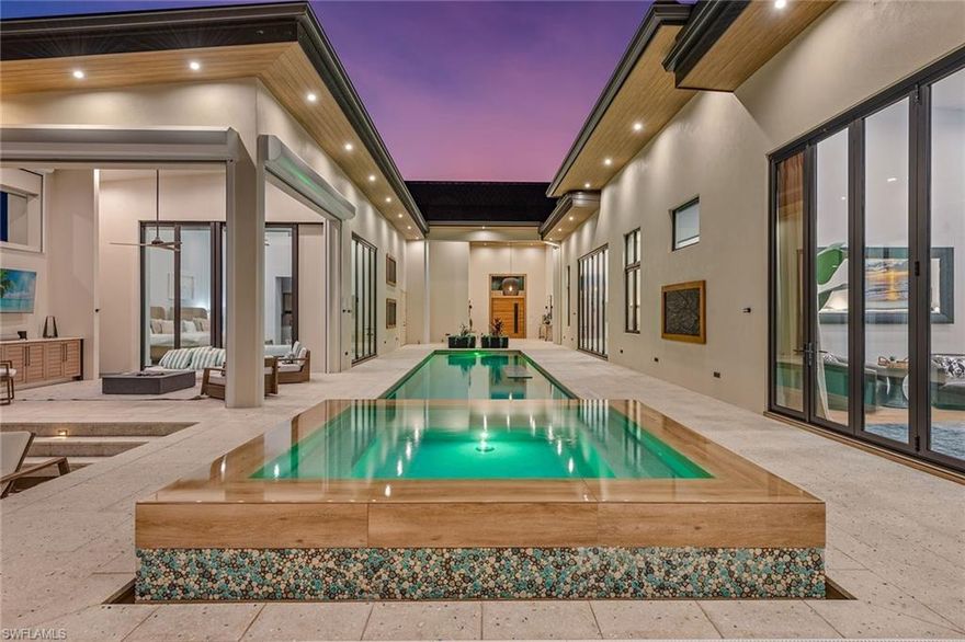 OWNER SAYS SELL — SIGNIFICANTLY REDUCED!
Introducing “Makaha” — A One-of-a-Kind Modern Tropical Courtyard Estate

Prepare to be captivated by Makaha, an extraordinary custom-designed Tropical Polynesian masterpiece that redefines island luxury living. A water direct home, just minutes to Open Gulf waters!  Offering over 5,400 square feet under air, this stunning 4-bedroom, 4.5-bath estate is centered around a dramatic private courtyard and includes a spectacular detached casita villa featuring a spacious primary suite, wet bar, laundry, and both indoor and outdoor showers.

From the moment you arrive, Makaha impresses with its architectural presence and seamless indoor–outdoor design. The expansive great room showcases 12-foot disappearing glass walls, opening effortlessly to your own tropical sanctuary. This private oasis is designed for both grand entertaining and tranquil relaxation, complete with a 50-foot lap pool, 12-person Euro-edge spa, fireplace lounge, firepit, covered dining terrace, and a fully equipped outdoor kitchen.

The gourmet chef’s kitchen is a culinary showpiece, featuring a massive butler’s pantry, soaring 14-foot beamed ceilings, and bespoke finishes of the highest quality—crafted to satisfy even the most discerning buyer.

Car enthusiasts will appreciate the rare 6-car garage, offering exceptional ceiling height to accommodate lifts—an ideal setup for collectors seeking both luxury and functionality.

Completing this tropical masterpiece is a private dock and boat lift with quick, direct access to the Gulf of Mexico, providing the ultimate gateway to Marco Island’s world-class boating lifestyle.

Built in 2022, this like-new modern estate embodies refined coastal living at its finest. Makaha is more than a home—it’s a dream realized.