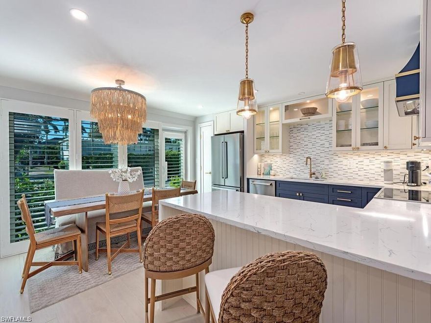 Just a short stroll from the pristine beach, bustling Saturday farmers market, and vibrant 3rd Street South, this stunning 2-bedroom, 2-bath condo offers an unparalleled lifestyle in one of Naples' most sought-after areas.Indulge in the elegance of this meticulously remodeled first-floor unit, showcasing opulent furnishings and exquisite impact doors and windows. This poolside haven embodies refined living, with no detail overlooked in its comprehensive renovation. Enjoy striking oversized wood porcelain tile flooring, custom trim, and elegant 3-panel solid core doors fitted with premium Emtek hardware, creating an atmosphere of sophistication.The gourmet kitchen is a culinary dream, featuring professional-grade appliances, custom cabinets with polished stainless steel and glass fronts, and designer lighting that illuminates the space. A stunning quartz peninsula with a captivating waterfall edge serves as the perfect centerpiece for entertaining or quiet moments.Equipped with full hurricane protection, including impact-rated windows and doors, this home offers peace of mind during storm season. The building has successfully passed all required Florida condominium inspections, ensuring structural soundness and compliance with current standards.Located just steps from the Gulf and the world-famous Naples Pier, enjoy morning walks along the beach, sunset views, and the charm of nearby Third Street South and Fifth Avenue South, where fine dining, boutique shopping, and art galleries await. Parks like Cambier Park and Baker Park are also just minutes away, providing green space and recreation right in town.This move-in-ready home is ideal as a primary residence, seasonal retreat, or investment opportunity. With its turnkey furnishings, updated interior, and unbeatable proximity to the beach and downtown Naples, this property captures the very best of the Naples lifestyle.