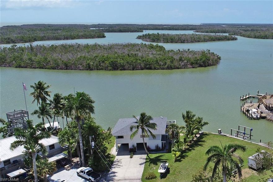 RARELY available southern exposure, HUGE unobstructed MILLION $$$ view point lot. The possibilities are endless with this ONE-OF-A-KIND property - build your dream, live in 1 unit & rent other. This property with these water views will not last long.  True Island Living at its best! Escape from it all- watch the dolphins, manatee, stingrays, birds, boats go by all from almost anywhere in your home. Huge waterfront with approx 140 ft of seawall built 7 yrs ago, NEW ROOF DEC 2018. Wrap around deck with plenty of entertaining space. Tons of covered shade space below for grilling, fishing, and relaxing the day away. Upstairs boasts 2 large bedrooms, 2 bathrooms, wide open kitchen, and dining/living room that have been nicely remodeled and maintained. Transform your living space to the outdoors as you open up your sliders and invite your unobstructed views in. Downstairs is a separate non conforming recently remodeled 1 bedroom/1 bath apartment that instantly transforms you into feeling like you are in the islands away from it all the moment you walk in.  Solid rental history for last 7 yrs as well as 2020 rental season is almost booked out as well.