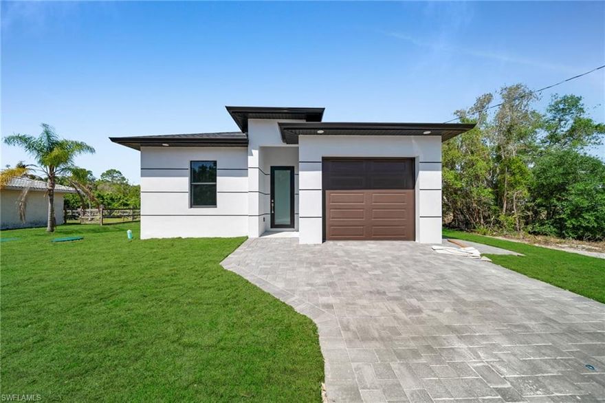 Newly constructed residence in Lehigh Acres offering 3 bedrooms, 2 bathrooms, and approximately 1,207 square feet of living area. The home features tile flooring throughout, quartz countertops, and an open-concept living and dining area. The kitchen includes all standard kitchen appliances and provides a functional layout for daily use. The primary bedroom offers a private en-suite bathroom, with two additional bedrooms and a full secondary bath. Built with modern materials and construction standards