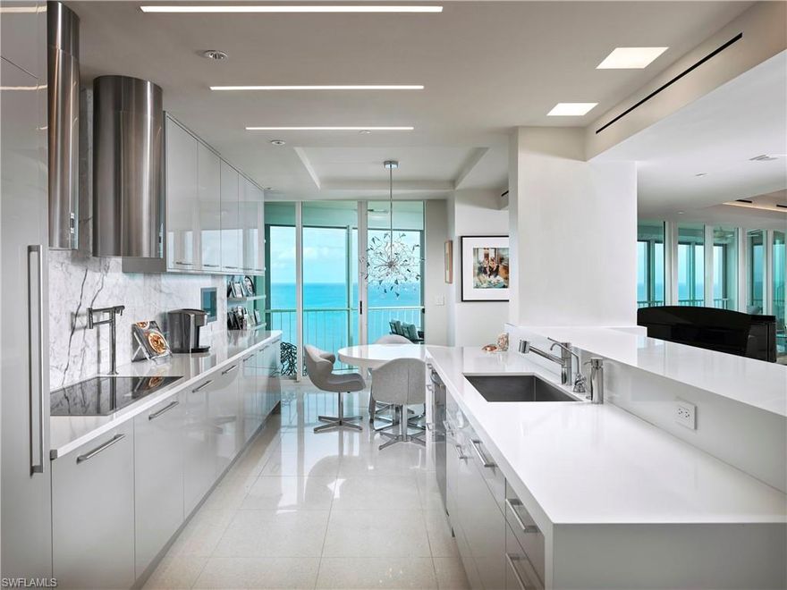 Clean, contemporary and directly on the beach this penthouse apartment in Le Ciel Park Tower was designed with the hues of Gulf blues in mind. Simple yet elegant finishes such as modern recessed trim, Terrazzo flooring, tray lit ceilings, sleek lacquered custom cabinetry, thick white countertops and marble slab backsplash give a monochromatic feel providing the perfect canvas to make your own. Three bedrooms and a study, access to guest suites through the building and a three + car private enclosed garage, just an elevator trip away make this penthouse ideal for both seasonal and full-time residents and their family & friends. Wake up to the sounds of the surf from the spacious owner’s suite with access to the western facing lanai offering unmatched 18th floor views.  Additional features include Gaggenau, Wolf & SubZero appliances, electric blinds on nearly every window, custom built in cabinets, floor to ceiling windows and convenient walk-in pantry with wine cooler.  Le Ciel Park Tower is a prime building in Park Shore and offers a recently renovated lobby, club room and only steps away from the soft sand of Park Shore beach as well as shopping and dining in the Venetian Village.