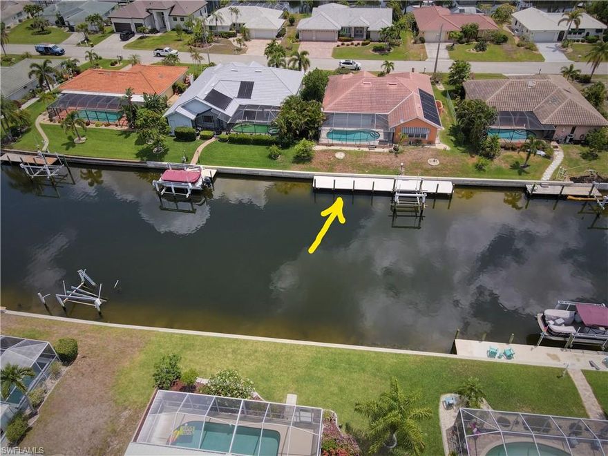 Great opportunity in a GREAT neighborhood! 3 bedroom, 2.5 bath waterfront living on a desirable Punta Gorda Isles cul de sac. SO peaceful! WIDE canal home is minutes to Charlotte Harbor with direct access to the Gulf of Mexico. 80 ft of waterfront  (city maintains) concrete seawall w/ new (12/2021) 65 foot dock & 12k pound lift. Driveway & walkway feature pavers. Enter the double leaded glass doors into foyer w/ dining & living areas featuring plant shelving with up-lights. Your eyes will be drawn through the disappearing sliders to the view.  Private suite w/sliders to the lanai, dual closets, bath w/ separate tub & shower, dual sinks, & a water closet. Kitchen is the center and heart of this home w/ two pantries, granite counters, built in desk & breakfast bar. The open floor plan continues from the kitchen to the breakfast nook, on to the spacious family room- all with water views. 2 bedrooms & a bath, laundry room w/ sink & storage complete the home. 2 car garage is fully screened to capture those harbor breezes. Screened lanai features: sun shade, solar-heated gunite pool, half bath & outside shower. 2021 new: Dock, H2O heater, Plumbing