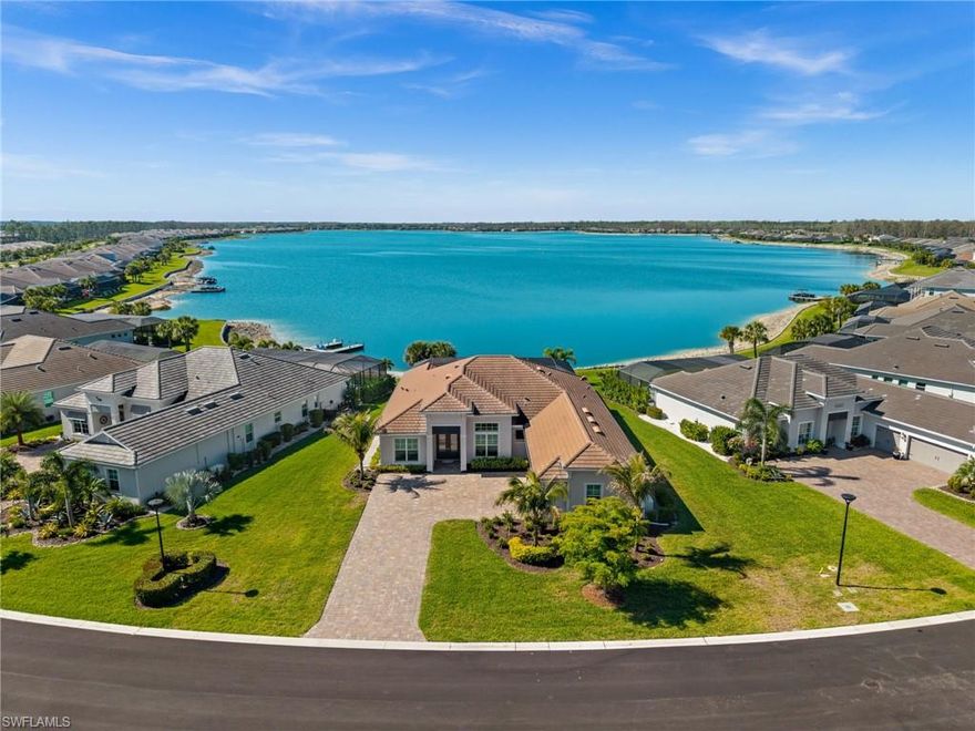 Breathtaking lakefront views await from one of the most coveted south-facing homesites in Vista at WildBlue. This exquisitely appointed 3-bedroom + den, 3-bath residence with a 3-car garage is a seamless blend of sophistication, comfort, and effortless resort-style living.

Step inside and experience a thoughtfully curated open-concept design, with a refined formal dining space, expansive great room and a stunning chef-inspired kitchen. Walls of soaring sliding glass doors bathe the home in natural light and open gracefully to the lanai, creating a truly seamless indoor-outdoor lifestyle.

Designed for unforgettable entertaining, the outdoor retreat is nothing short of spectacular. Enjoy a sparkling pool and spa, a fully equipped outdoor kitchen, elegant travertine decking, electric storm shutters, and a panoramic picture-frame screen that perfectly captures endless water views. 

The gourmet kitchen is a showpiece, featuring upgraded cabinetry, sleek quartz countertops, premium stainless-steel appliances, and a natural gas cooktop, perfectly suited for both casual gatherings and elevated dining experiences.

The owner’s suite is a serene sanctuary, offering tranquil lake views and a spa-like ensuite designed for ultimate relaxation. Each guest bedroom is generously appointed with its own private bath, including one with direct access to the pool, ideal for hosting with ease and privacy.

Every detail has been thoughtfully enhanced, Impact windows and doors throughout, whole-house Generator, tankless water heater, insulated and air-conditioned garage with mini split, epoxy flooring, designer lighting, upgraded tile throughout, and quartz surfaces that elevate every space.

Residents of Vista at WildBlue enjoy an unparalleled lifestyle with world-class amenities which includes an elegant lakefront clubhouse with indoor and outdoor dining, resort-style and lap pools, a full-service spa, state-of-the-art fitness center, tennis and pickleball courts, bocce ball, boating and kayaking, and more.

Perfectly positioned near several dining options, premier shopping, Southwest Florida International Airport, and the pristine beaches of Bonita Springs and Naples, this exceptional residence offers the ultimate blend of luxury, privacy, and everyday indulgence.