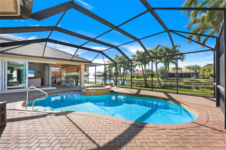 Within one of Naples’ most coveted enclaves, this exceptional residence unfolds with intention, elegance, and quiet confidence—enhanced by a NEW ROOF and gutter system (December 2025), this home offers peace of mind and long-term value. 

Enter through grand double doors into a formal living room where sweeping views of the shimmering pool and tranquil lake immediately set the tone. Spanning over 3,000 square feet of thoughtfully designed living space, the home balances refined luxury with effortless comfort.

The oversized primary suite features a bay window and spa-inspired bath, while custom closet systems reflect a commitment to quality at every turn. The chef’s kitchen is both functional and open, showcasing a Thermador gas stove and grill, a GE Monogram venting hood, and additional GE Profile and Bosch appliances—all arranged in an open-concept flow into sun-filled great room areas, perfectly designed for connection, entertaining, and everyday ease.

The expansive family room with 70 inch, top of the line, LG TV opens seamlessly to the kitchen, creating an inviting, light-filled heart of the home. The main primary retreat enjoys serene views of the outdoor pool, spa, and lake—offering front-row seats to Naples’ unforgettable sunsets. The renovated primary bath is a true sanctuary, complete with separate white quartz counters, a luxurious soaking tub, a separate walk-in shower, and individual men’s and women’s vanities and water closets.

Two additional generously sized guest bedrooms each feature dedicated baths, ensuring comfort and privacy for family and visitors alike. Outdoors, zero-corner impact sliding doors disappear to reveal a sprawling paver pool deck, blending indoor and outdoor living. The covered lanai—equipped with a retractable awning, large TV, and gas grill—creates the perfect setting for relaxed evenings and elevated entertaining.

Set in the very heart of Naples, this residence is an expression of thoughtful design, luxury, and relaxing Florida living—made even more compelling and insurance savings with a newly installed roof .