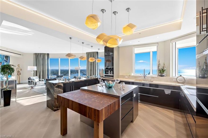 360 degree spectacular long range views as far as the eye can see. Take in the Gulf of Mexico, beach, coastline, Venetian Bay, City views & more from this 23rd floor beachfront penthouse. 10’+ ceilings and floor-to-ceiling glass throughout welcome dazzling views into every room.  Fully furnished & move-in ready with artisan quality brands & finishes to exceed the most discerning sensibilities. Gorgeous Bois Chamois wide plank Rustic White Oak flooring throughout, SubZero / Wolf / Gaggenau / Valli & Valli / Toto & more, programmable Lutron custom lighting & window treatment systems, solid wood cabinetry, specialty wall & plaster features all top of the line too much too many to list. 4 separate outdoor terrace areas totaling an additional 2,000+ square feet, private elevator foyer with owner-controlled security settings. A 40’+ boat dock on Venetian Bay is included too! Naples beachfront penthouse living at its finest: gated entry at Gulf Shore Boulevard, Venetian Village’s waterfront shops & dining conveniently located directly across the boulevard, 3 deeded garage parking spaces in secured garage under building next to elevator lobby, deeded cabana alongside spacious pool area.