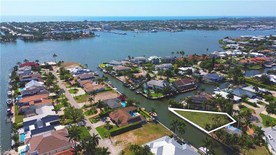 An incredible opportunity to bring your dream home to life on this extraordinary waterfront lot in Naples' prestigious Royal Harbor community. This exceptional property boasts 158 feet of water frontage, offering bridge-less access to Naples Bay and the Gulf of America with ideal southern exposure that paints the sky with breathtaking sunsets. Prepared with an entirely new seawall, envision your custom architectural masterpiece on this site. There is also a complete set of permit ready plans by renowned MHK Architecture. The prime cul-de-sac location offers a quick idle out to Naples Bay, or mere minutes to 5th Ave. S and the pristine white sand Naples beaches.