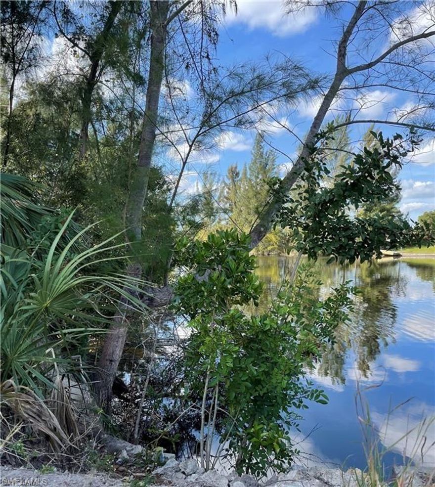 A beautiful lot with water views to build your new home! 128’ of waterfront!  
You can boat and fish from your own private dock on a freshwater canal. 
Gator Circle Park nearby. 

Convenient to shopping, dining, and the SWFL airport!