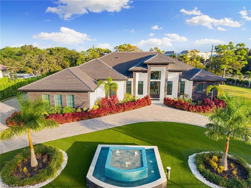 2024-BUILT LUXURY ESTATE ON 1.12 ACRES IN NAPLES’ HIGHLY COVETED PINE RIDGE! This new construction property offers the rare opportunity to enjoy true privacy on acreage with no HOA—providing endless possibilities to add future amenities or additional living space! This contemporary masterpiece showcases over 5,000 sq ft under air of bright & airy living space, featuring 5 bedrooms + den, 5 bathrooms, a 3-car garage, and hurricane-impact windows & doors throughout. Every detail has been expertly curated, from the oversized tile floors to the soaring coffered ceilings accented with custom wood paneling. The stunning modern chef’s kitchen boasts beautiful quartz countertops, dual-tone white cabinetry, high-end appliances, a spacious walk-in pantry, and an adjacent wet bar with a wine fridge. Step outside to your private resort-style oasis, offering an expansive entertainment deck, a large pool with tanning shelf, a spa, water features & a covered lounge area, and a summer kitchen with an oversized eat-in island—ideal for gatherings or relaxed al fresco dining. The luxurious primary suite offers direct access to the pool deck and a spa-like bathroom adorned in marbled tile, complete with dual vanities, an oversized shower, and a freestanding soaking tub. This estate includes fencing around most of the perimeter and is enhanced by lush landscaping, including a serene water fountain in the front yard, creating the ultimate private retreat. Pine Ridge is the perfect setting to enjoy peaceful acreage and convenience—located in an “A-rated” Collier County school district and minutes from Vanderbilt Beach, Waterside Shops, Mercato, and the world-class shopping and dining of 5th Ave and 3rd Street South.