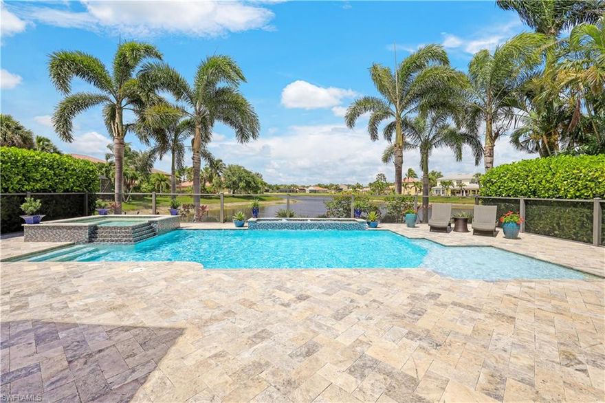 This impressive "Pearl" floorplan home is the ultimate Naples retreat or full time residence. Situated overlooking the lake, this updated home offers a grand floorplan with 12' and vaulted ceilings, tons of windows, and an abundance of architectural detail that you do not find in new homes. The custom salt water heated pool with oversized eight person spa and sunshelf surrounded by travertine marble decking is the ultimate backyard oasis. Inside, you will find no detail was overlooked. A long list of upgrades include: diagonal tile & wood floors throughout (no carpet anywhere); extensive trim work including crown molding, modern columns, and window casings; plantation shutters; solid wood raised panel cabinetry; glass front doors; IMPACT WINDOWS & DOORS; SONOS in ceiling speakers; two zone AC; custom shower tile with frameless shower doors; extra landscaping; & more! "Club at Saturnia Grande" offers resort pool, hot tub, lap pool, kiddie pool, saunas, fitness center, billiards room, ball room, 4 tennis courts, basketball court, and more! HOA fees incl. landscaping, irrigation, clubhouse amenities, manned gate, alarm monitoring, cable TV, internet, & home phone line! NO CDD Fee!