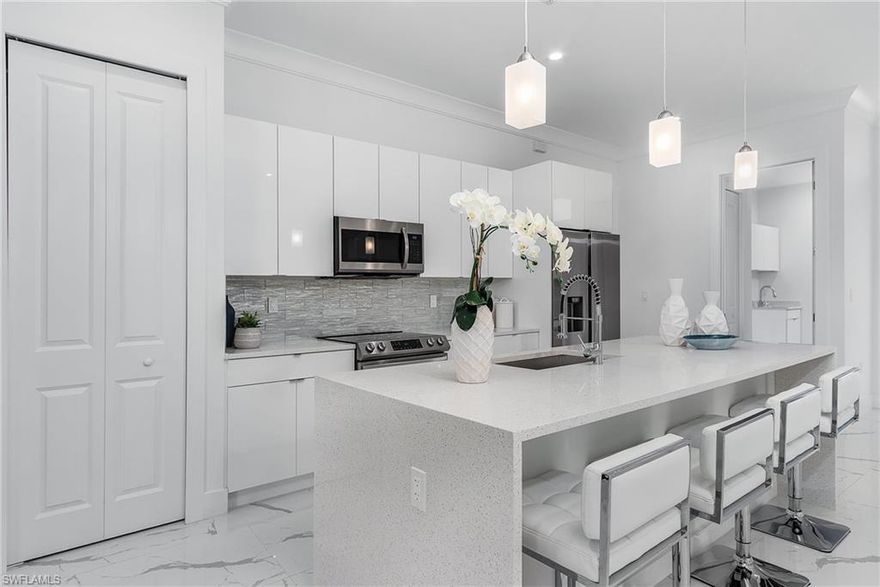 Gorgeous new construction home on 2.27 acres of 100% upland property with plenty of room for out buildings, guest home, workshop, or whatever you can imagine! This open concept, split floorplan design with soaring ceilings has 4 bedrooms, a den, and 3 bathrooms with almost 2400 sq ft under air giving everyone their own space to work, unwind and relax. The modern kitchen design has custom white cabinetry, large center island with quartz countertops and stunning waterfall edge. The oversized main bedroom boasts 2 roomy closets and a luxurious ensuite featuring a frameless glass door, tiled shower with two showerheads, stand alone tub, and dual sinks. The home has all impact windows and doors, ready for storm season. Bring your dreams, your imagination, and your toys. Golden Gate Estates has no rules, no HOA and no fees. The home is just days from completion and ready for its new owners!