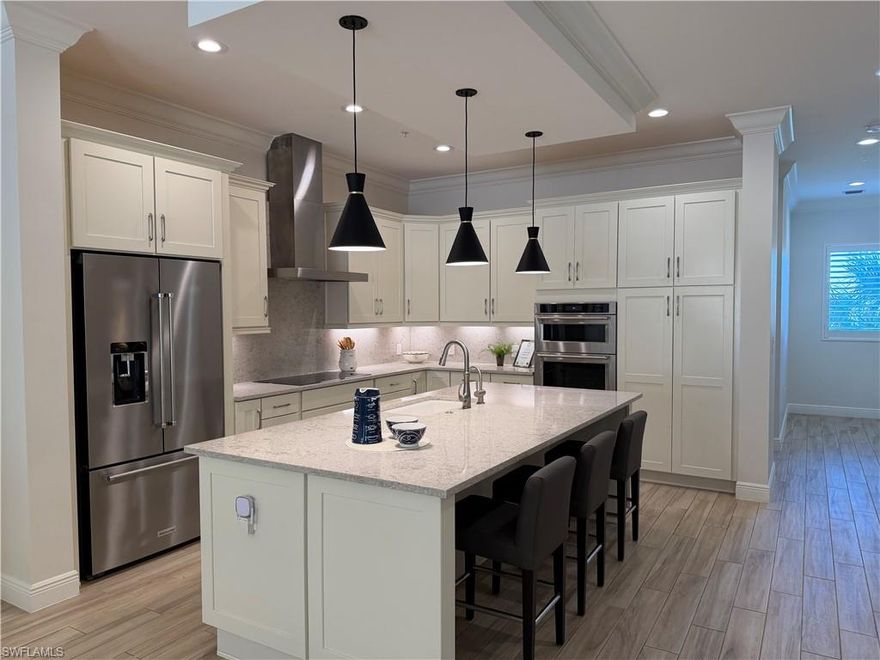 Welcome to Genova in Estero, where coastal living, prime location and exceptional amenities come together. This Expanded Tursi model, second-floor end unit offers a comfortable and functional layout with 2 bedrooms plus a den, or 3 full bedrooms providing flexible space for a home office, reading room, or additional bedroom area. This condo enjoys added natural because it is located on the corner/end and has incredible water, lake and fountain views. Southern exposure! Features include KitchenAid induction glass cooktop (5 burner), built-in-wall microwave and oven, crown molding throughout, wood look tile in main living areas, plantation shutters and custom window treatments. Step onto the 16x20 screened lanai, covered lanai off owner's suite 12x8, or expanded private outdoor living area on building courtyard deck. The community pool is located just across from the building, making it easy to enjoy a refreshing swim or exercising in the fitness room. The interior has been professionally staged for new owners. Genova is known for its beautifully maintained grounds, walking paths, and prime Estero and Coconut Point location. Just minutes to Coconut Point and Gulf Coast Town Center - a wide selection of dining and entertainment options. Professional photos coming soon!