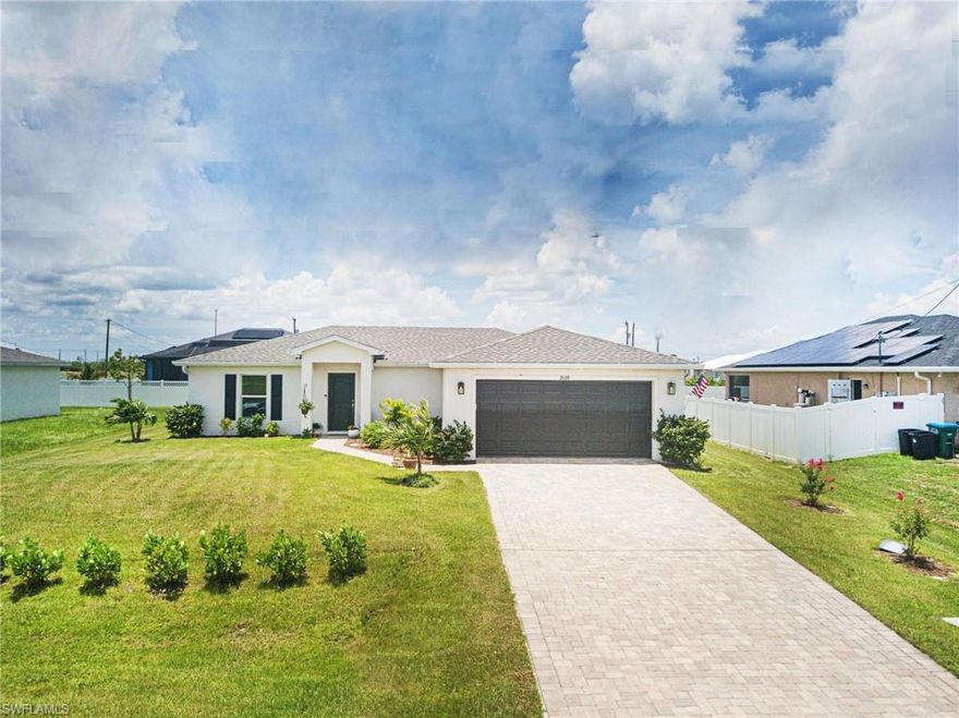 Better Than New – Step into a home that offers more than just the basics. Since home was completed at the end of 2022 & sellers moved in - the sellers have thoughtfully upgraded this property, ensuring it stands out from the rest. This stunning 3-bedroom, 2-bathroom home in the desirable Northwest Cape Coral close to Festival Park (incredible park currently under construction)boasts numerous enhancements including an extended brick paver patio, new gutters and downspouts, sleek refrigerator, washer, and dryer, ceiling fans, mirrors and towel bars, stylish light fixtures, and beautifully enhanced landscaping.  The open great room offers a bright and inviting space with luxury plank flooring, perfect for entertaining. The gourmet kitchen features white shaker cabinets, granite countertops, stainless steel appliances, an island with pendant lighting, and pantry. The kitchen seamlessly flows into the great room, which features a cathedral ceiling and sliders to the patio. The spacious master suite includes an attractive bathroom with double sinks, a tub/shower combo, and  large walk-in closet. Two ample-sized guest bedrooms share a well-appointed guest bathroom. The inside laundry room is equipped with a full-size stackable washer and dryer. 
Outside, the extended brick paver patio is perfect for outdoor gatherings and relaxation, while the enhanced landscaping adds to the home's curb appeal. The driveway, complemented by brick pavers, enhances the charming aesthetic of the property.

This home is truly move-in ready, offering a blend of comfort, style, and thoughtful upgrades. Experience the best of Northwest Cape Coral living in a home that feels better than new.
