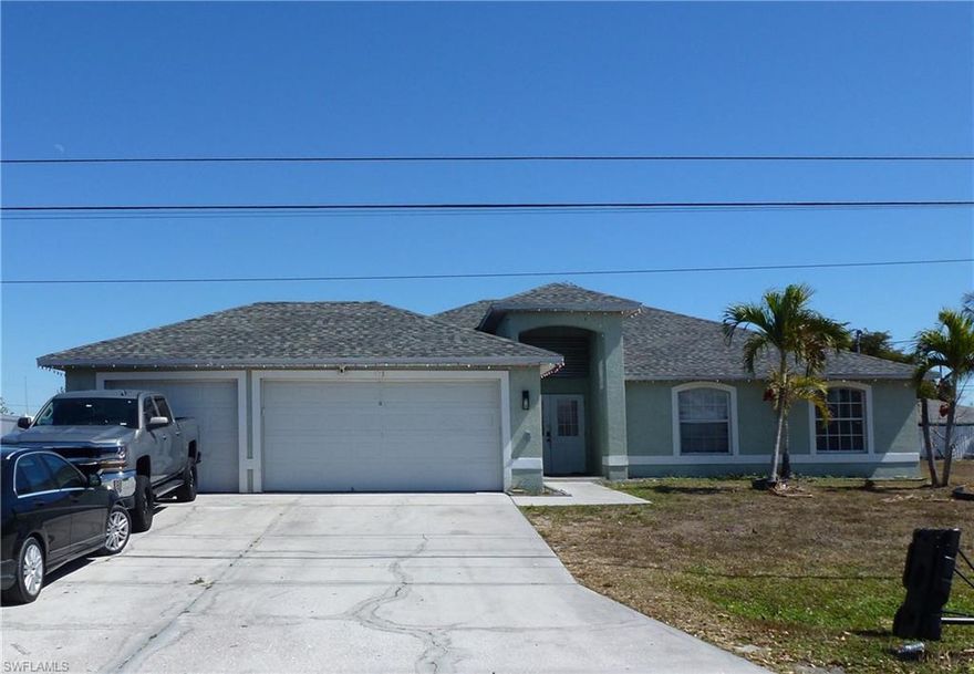 This is a very unique house.  It has 4 bedrooms, 2 bathrooms, 3 car garage and it's located on a triple lot which is 50% larger than a standard lot in Cape Coral. It has relatively new roof that was installed in 2022.  There is plenty of space to expand the house, add a pool and a large shed, and a fence in the front as it has already a privacy fence on the back.  It's located one street away from Del Prado Blvd, and within walking distance to the hospital and a school.  It's currently occupied by tenants who pay $2,600/month and are interested in staying.  They're on a month to month lease.  The shed in the back is theirs and doesn't convey.  The tenant will dismantle the office in the third garage and restore the garage to its original shape.