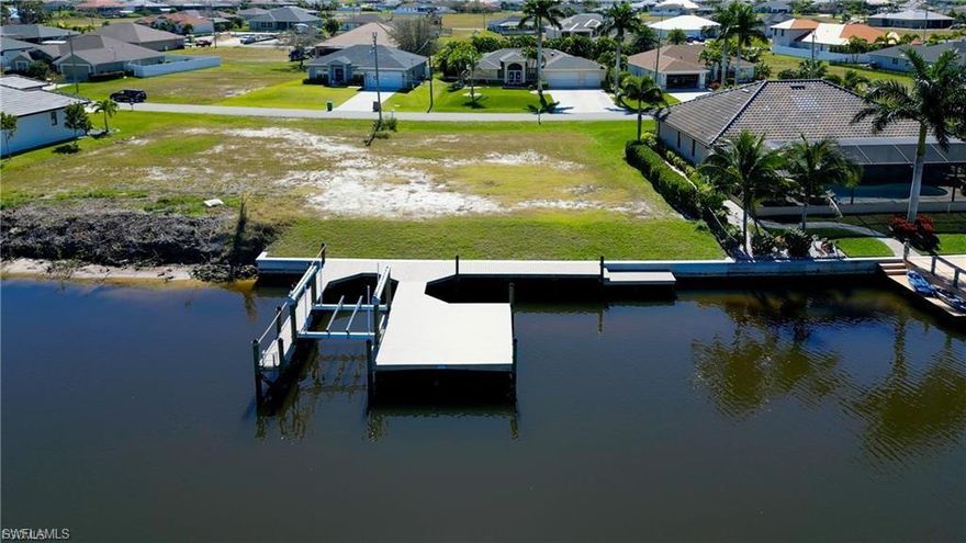 Oversized Gulf access lot with intersecting 250 ft canal view and 90ft of waterfrontage.  This lot had a new seawall and huge dock with 10,000 lb lift built in 2022!  There are amazing intersecting canal views, and you do not have to wait for a seawall or dock permit.