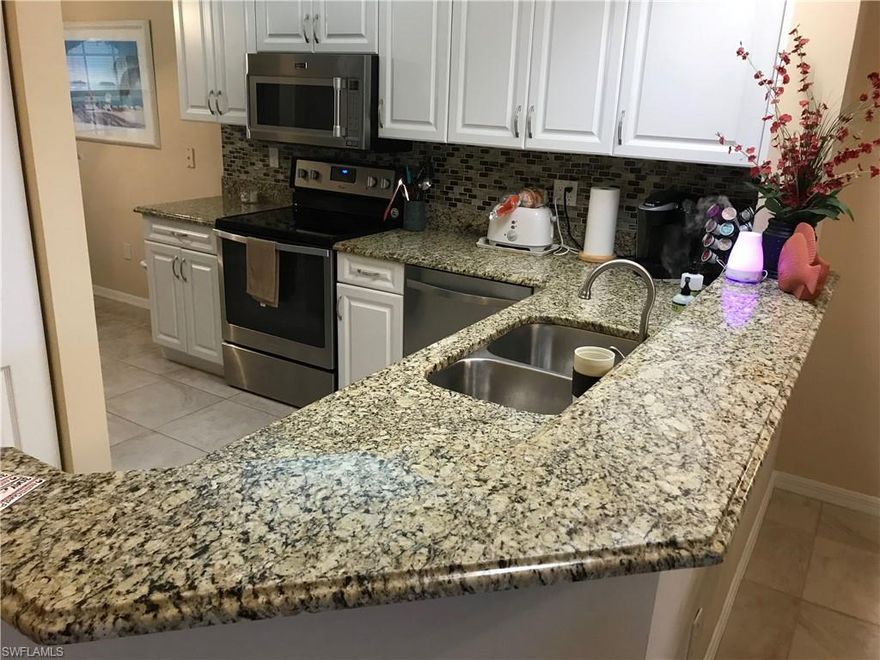 Updated Piper's Grove 2 bed/2 bath first floor condo with preferred southern exposure overlooking a serene lake with multiple water features. Tastefully, TURNKEY furnished unit features raised panel kitchen cabinets and granite counter tops, newer stainless appliances, tile and carpet, elegant bathroom cabinetry, and a reserved covered carport just steps away from your front door. Master bedroom includes Hilton Hotel bed. Building 2420 is the first building inside the main front gate, providing easy access in and out of the community with walking distance to the adjacent Publix grocery plaza, as well as one of the three heated community pools. The main Clubhouse offers a resort style pool, Har-true tennis and bocce courts, fitness center, and fishing pier. Recent roof replacement after Irma. Live the Naples lifestyle in the conveniently located gated community, desirable location with easy access to RSW airport, minutes to the beach, shopping and local churches and banks, as well as the ultra-popular Mercato with restaurants all near by.