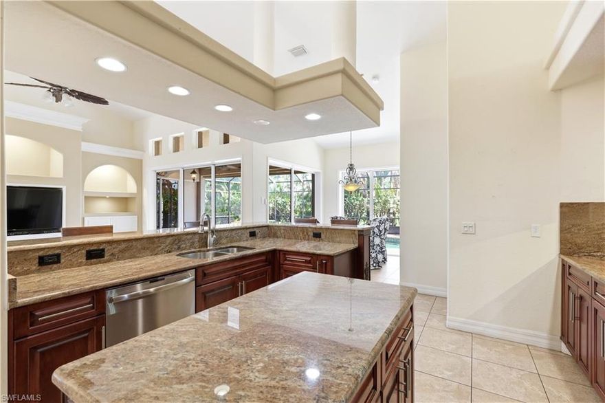 Experience the perfect blend of luxury and comfort at 911 Linkside Way, located within the premier gated community of Burnt Store Marina. This boating and golf paradise on Charlotte Harbor provides the ultimate Florida lifestyle for active residents. Peace of mind comes standard with this custom pool home, featuring a brand-new roof installed in August 2025 and a high-efficiency air conditioning system replaced in July 2024.

The residence showcases custom finishes throughout, starting with a main living area that features sophisticated built-in cabinetry and a dedicated media setup. High-end touches like plantation shutters and elegant transom windows allow for plenty of natural light while maintaining privacy. The guest wing is thoughtfully designed for versatility, offering a Murphy bed paired with a built-in desk to easily transition from a home office to a welcoming suite for visitors.

The primary suite is a true private retreat, offering enough space for a full seating area and direct sliding door access to the screened-in pool. The attached ensuite bathroom resembles a high-end spa, complete with a massive walk-through shower featuring dual niches, a modern freestanding soaking tub, double vanities, and two spacious walk-in closets.

Culinary enthusiasts will appreciate the kitchen’s functional layout, which includes an electric range equipped with a convenient pot filler and a newer dishwasher. Just steps away, the laundry room provides extra storage with a pantry and a dedicated utility sink.

Outdoor living is centered around the private screened pool area, while the oversized two-car garage features a dedicated bump-out specifically for golf cart parking. For added security, the property includes a generator and a transfer switch, ensuring you are prepared for any season.