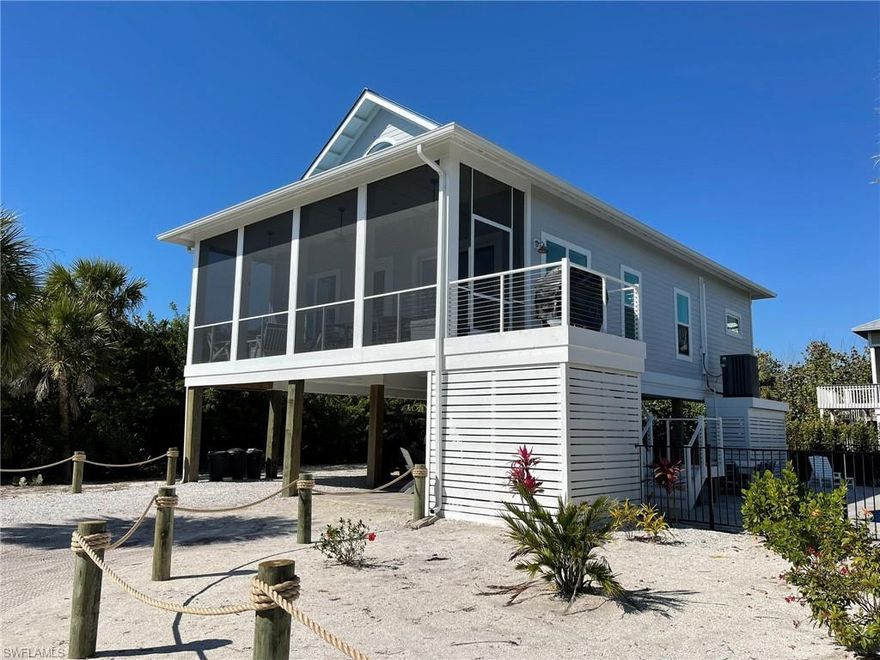 Introducing the Gorgeous Brand "Waid N Sea" Beach House! Located on the Barrier Island of North Captiva. This Special 4 Bedroom, 3 Full Bath Beach Home with Private, Heated, Salt Water Pool Home! Fantastic Vacation Rental Bookings and Full Licensed Property Management already in place! This Superb Beach House is located only steps to the Ocean on the most desirable High and Dry Side of the Island. It is approximately 500 Feet from the Best Island Beach "Butterfly Beach" which offers White Sugar Powdered Sand, Amazing Gulf Ocean Views and Wildlife, and World Class Fishing and Shelling. You will find no cars here in paradise as transportation is only by foot, bike, or golf carts. Unspoiled and Unrushed with Beauty all around you, North Captiva Island and "Waid N Sea" offers you an Amazing Vacation Destination. Waid N Sea’s interior is amenity packed with all of the comforts of home! The Island's Beauty, Native Wildlife and Sea Life, State Preserve, Water Sports, World Class Shelling, and Fishing Await! The Unforgettable Sunsets will take your Breath Away!  Some Features Include: Soaring Ceiling, Great Room Floor Plan, High End Finishes, Recess Lighting, High Speed Wi-Fi, Under Stair Storage, Large Beautiful Kitchen with Island, Wonderful Entertaining and Dining Areas Inside and Out, Private Salt Water Heated Inground Pool, Large Paver Pool Area, Outdoor Shower, Huge Ground Level Bar with Built In Grill and TV, Attached Garage, Lots of Carport Parking, Huge Front Screened Balcony and Open Back Balcony off of the Amazing 2nd Story Loft Main Suite with Full Bath.