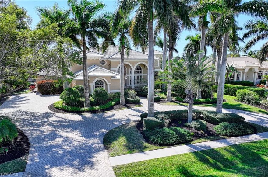 Marco Island Estate Area Best $ per sq ft! Welcome to an extraordinary waterfront estate in the exclusive Estates section of Marco Island—a residence that defines timeless grandeur and expansive luxury. Positioned on a 125 x 175-foot lot with southern exposure, this architectural gem enjoys unparalleled natural light and a very short putt to open water. With a first-floor elevation of 11.3 feet, this 4 Bed | 3 full + 2 -1/2 Bath estate exudes presence and sophistication from its' stately circular drive, lush tropical landscaping, and striking night lighting which makes a lavish impression from the moment you arrive. Cherished by the original owners since its construction, this home has been meticulously maintained, reflecting a legacy of thoughtful care and refinement. Every space is designed on a grand scale, blending architectural beauty with livability. Step inside and be captivated by the tray and volume ceilings, accentuating the expansiveness of the rooms. The great room entry unfolds with a grand entrance through pocket sliders, with floor to ceiling sliding doors and picture windows seamlessly merging indoor and outdoor spaces for an unparalleled coastal living experience. The primary suite is a private sanctuary, featuring 3 custom closets (one a part of an addition designed for both luxury and practicality.) A charming den off of primary (also added), offers a tranquil retreat, perfect for a home office or intimate lounge. An elevator connects the levels, adding modern convenience to the upstairs, where three bedrooms ensure privacy for family and guests, including a suite and one ensuite with a large tub. A media/TV room (could also be a bedroom) creates a dedicated space for entertainment. Outside, the screened lanai is a true private oasis featuring a pool with integrated jacuzzi that is surrounded by lush landscaping beyond with three majestic palms adding to the tropical ambiance that frames the estate's waterfront. The convenient outdoor summer kitchen, complete with a built-in refrigerator, makes entertaining effortless, whether hosting grand celebrations or intimate evenings under the palms. For boating enthusiasts, a 125ft. waterfront with 2012 Seawall features a U-shaped dock providing direct Gulf access, inviting you to experience endless waterfront adventures. A side-facing 3-car garage ensures curbside elegance and functionality. Schedule your private tour today and experience the finest in Marco Islands' luxury waterfront lifestyle.