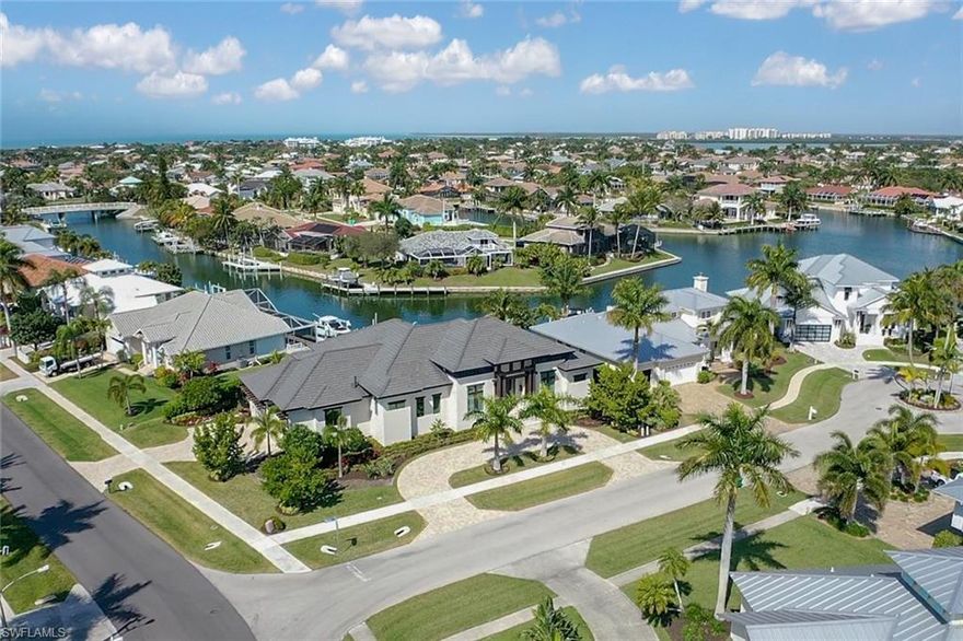 Luxury coastal living on Marco Island! Just built in 2018 and offering luxury features throughout including gourmet designed kitchen (w/ Wolf gas cooktop & seamless quartz countertop on island), custom woodwork, designer light fixtures & cabinetry, zero corner sliders in dining area, built in bar w/ 2 wine coolers, contemporary doors, volume & tray ceilings, and beautiful built-in entertainment center in great room. You will love spending time on the open rear lanai that offers a heated pool & spa, covered sitting area w/ summer kitchen, large pool deck, gas fire pit, and a private boat dock w/ Captain's Walk & carving station. Situated on an oversized corner lot w/ circular drive at front of home and a private drive leading to a 3-car garage. Marco Island is a true island retreat w/ amazing white sand beaches and lots of activities for every member of the family. Tigertail Beach is just bike ride or walk from this home, as well as access to everyday conveniences such as shopping & dining that the island has to offer. In just minutes you could be boating on the Gulf of Mexico ... taking in the sun and enjoying top-notch SWFL fishing.