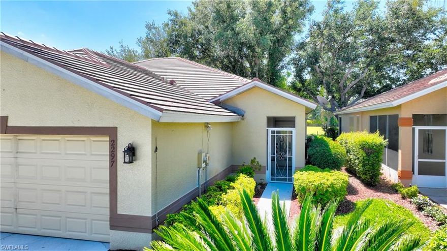 Like brand new only better! This twin villa has been gorgeously updated and can be purchased with or without the furnishings. Featuring Plantation Shutters and tiled throughout, newer soft-close kitchen cabinets, granite countertops, roof, shower, all hardware & faucets. New LG washer and dryer set and new gutters. This property is located just east of Gateway in Lehigh Acres and within the 24-hour attended gates of Westminster Golf Community. Featuring a stamped concrete extended lanai shaded with mature trees overlooking the golf course through a picture window screen. You'll find that you want to spend most of your time enjoying the breezes and peace here. Restaurant/Pub on site- you never have to leave the gates for a Happy Hour. This villa is easy maintenance and all furnishings are negotiable. The Club at Westminster is a public course with a variety of golf memberships available. Westminster amenities include a Community geothermally heated pool and spa, pickleball, tennis, basketball, exercise room, bocce, ping pong and is a very socially active community. Food Truck nights, golf tournaments, Christmas Golf Cart Parade, Children's events, Poker Runs, and groups of all kind ranging from Bible Study, Euchre, Bingo, Mah Jongg, Bunco, Book Club and MORE! If you are bored living here it's your own fault! Pay NO CDD, NO MANDATED GOLF FEES, HIGH VALUE HOA's, COUNTY-ONLY TAXES. A garage screen has been ordered and will be delivered after the exterior of the building is painted. The exterior color will be beige. MORE PHOTOS COMING SOON!