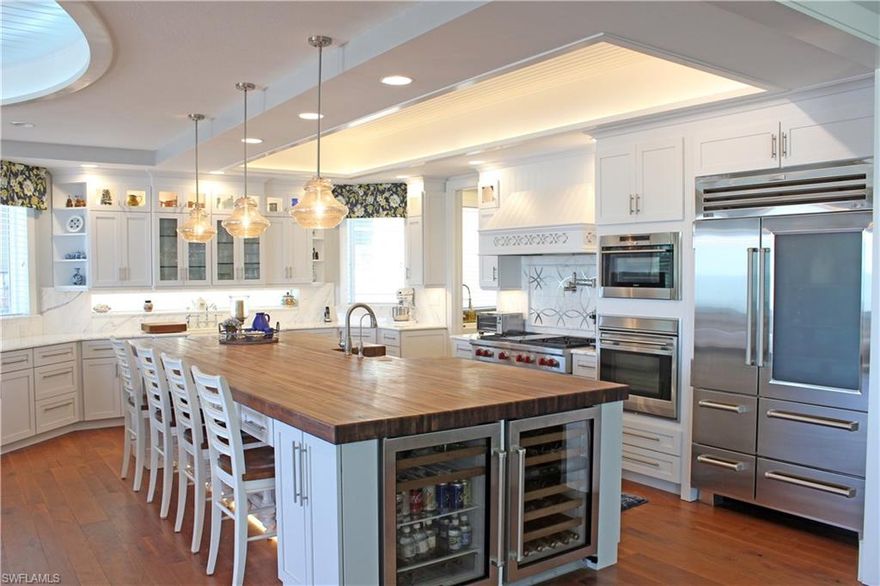 Fort Myers Beach Gulf Front!  ATTENTION INVESTORS: Although this home has never been rented, the projected vacation rental income exceeds $450,000 per year (with a 25% vacancy rate).  This custom built gem has a very rare stand-alone 2 bedroom guest cottage.  This state-of-the-art gourmet kitchen boasts Wolf, Sub-Zero and Bosch appliances, including a glass door refrigerator, conventional oven, convection oven, steam/bake oven, stand alone ice maker, beverage and wine coolers. This spacious kitchen and butler's pantry have extensive white cabinets with white marble countertops and backsplash. There is a Lutron package for lighting, blinds, security system and for showcasing a marble lined glass elevator.  There is a 13x5 foot 3 inch thick walnut dining island and a 6 burner gas cooktop. The luxurious 8 seat theater features a 4K Sony movie projection system. The Master Suite offers glorious Gulf views, volume paneled ceilings, steam shower with double heads, and an enormous walk-in closet/dressing room.  New A/C. There are walnut hardwood floors throughout this gracious home. The beachside pool is surrounded with an expanse of travertine tile. For the discriminating Buyer/Investor.