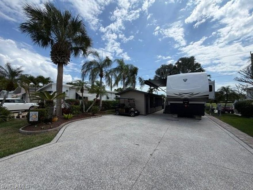 This oversized 45x90 RV site has been upgraded to make it move-in ready.  This property is being sold as a full package including a 2022 Vanleigh Beacon 41LKB fifth wheel with built stairs, a newly constructed screen room with windows and an attached shed that includes a washer and dryer, sink, toilet and plenty of room for storage. The screen room is fully furnished with a pull-out couch, chairs, a dining table, a large screen tv and much more. The concrete pad is expanded to give a great deal of living area and parking area.  The location of this site  in Silver Lakes is near the middle of the resort and has a fantastic view of the golf course and lake.  Not many opportunities to walk in to a property with all the amenities this one includes.  The finishing touches to this site also include the full painted concrete pad, tasteful tropical landscaping with night lighting, and the open air patio off the back of the property to enjoy the wide open view!