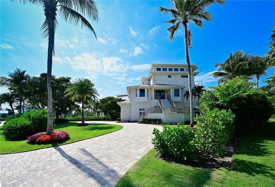 Perhaps Barefoot Beach's most private and luxurious 4 story gulf front estate, this stunning property is truly like no other in the community. Sprawling 9,500 Total Sq. Ft. this custom luxury home on an expansive double lot that offers Barefoot's finest landscaped front yard and largest driveway.  This incredible home offers all the cosmopolitan coastal living, but also offers a special level of privacy that makes this a truly rare opportunity and not one to be missed! Original concrete pilings & structure used, everything else was new in 2017 including impact windows and doors, standing seam metal roof, addition and still shows as new! Breathtaking sunsets and views of the beautiful Gulf of Mexico are found from nearly every room. Quality craftsmanship, details and luxurious appointments throughout. Interior amenities include, striking quartzite countertops in the kitchen, bar and out door kitchen, beautiful wide plank wood flooring throughout, marble baths, custom solid wood cabinets, custom ceiling details, private elevator, two laundry rooms, powder bath and many more upgrades. The wide open floor plan features large great room with u shaped sit at bar for 4 with wine and beverage cooler, amazing kitchen with solid wood custom cabinets, Thermador appliances including gas range, refrigerator freezer, microwave, dishwasher plus a hidden large pantry, ice maker, and open dining room all facing the gulf views.  Multiple sets of sliders lead to a huge outdoor deck with sectional in front of a linear gas fire place & outdoor TV plus large outdoor dining table and a covered lanai with summer kitchen featuring a gas grill with hood, sink, refrigerator and PVC cabinetry and quartzite counters with seating area all secured by electric shutters and electric screens. The Master bedroom features a sitting area, office area and a private deck overlooking the Gulf and beautiful master bath.  All four bedrooms are large size with king beds and have en-suite baths plus a 4th floor flex room with full bath to accommodate additional guests. There is garage space for at least 4 cars, golf cart, bikes etc., a garage door to the beach and the first living level is at 22’ (higher than todays new construction homes and FEMA zone AE10 - not V zone). There is room to construct a private pool on the ground level although the beautiful beach garden pool & spa was just refinished with new deck and landscaping. Barefoot Beach is located in Collier County and is a guard gated community with 24 hour patrolled guards. Amenities include clubhouse with fitness, tennis & pickleball. This home is offered with designer furnishings included.  A boat dock with 10,000 lb lift located just across the street is available as a separate purchase for $150,000 for premier boating, no bridges and quick gulf access.  A truly rare combination of exceptional beach home, swimming pool/spa, amenities, boating and security.