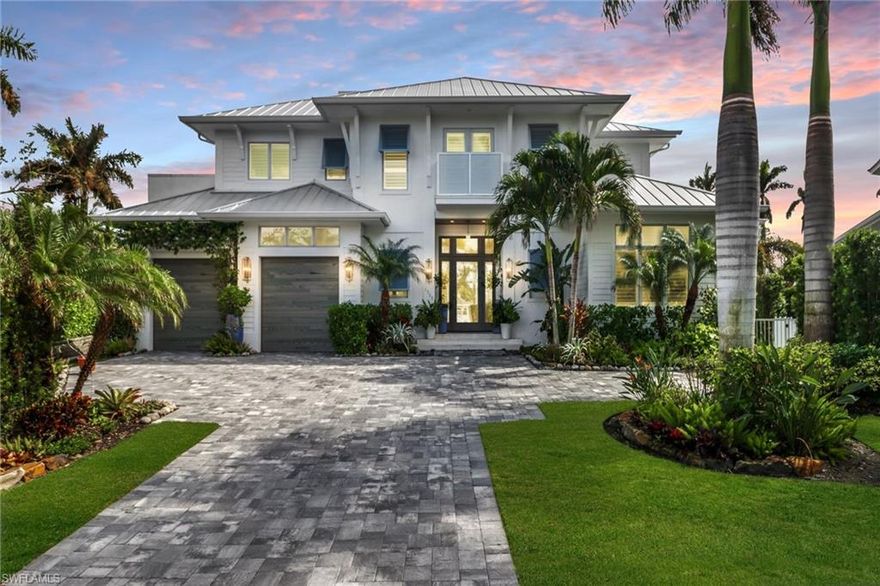 This waterfront home, situated on one of the best cul-de-sac streets in Royal Harbor, offers unrivaled access to the premier waterfront lifestyle that Naples is renowned for. Built in 2020, the home was designed by MHK and features luxurious shared spaces ideal for entertainment, while also providing private areas for relaxation.

The open floor plan facilitates seamless movement from the family room and dining room into the kitchen, with fully pocketing, impact-resistant sliding doors that lead outside. The interior boasts wide-plank wood flooring, coffered ceilings, custom built-ins, and designer finishes, creating an atmosphere of warmth and comfort.

The chef's kitchen is equipped with a large quartz center island, a Wolf gas range, double wall ovens, a Subzero paneled refrigerator, two Asko dishwashers, a beverage center, and a walk-in butler's pantry with a laundry area. The primary suite is conveniently located on the main level and includes an attached spa bath featuring a deep soaker tub, a smart Duravit toilet, a separate shower, dual vanities, and walk-in closets.

Upstairs, there is an additional expansive family room complete with a beverage center, along with three additional bedrooms, each featuring a walk-in closet and private bath, as well as a second laundry room. This floor serves as the perfect retreat for friends and family.

One of the standout features of this home is the waterfront living opportunity afforded by 148 feet of frontage on a 50' width canal, providing direct Gulf access along with a dock and lift for water toys. The outdoor living space offers an infinity edge pool with spa as well as a covered outdoor kitchen, dining, and lounge area ideally finished with fire place, and automated roll down screens and shutters.

For added peace of mind, the home is equipped with a whole house generator.