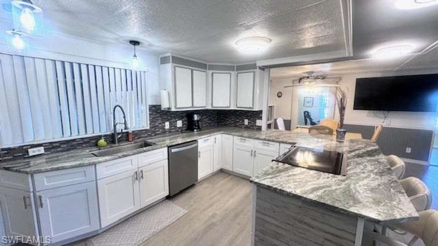 Welcome to your dream home in a desirable 55+ gated community! This beautifully remodeled 2-bedroom, 2-bath manufactured home offers numerous upgrades and comes fully furnished, making it truly move-in ready.  The updated kitchen features granite countertops, a decorative backsplash, stainless steel and black appliances, and durable vinyl flooring. A newer A/C system installed in 2023 provides year-round comfort, while plumbing updates and additional granite improvements completed in 2025 add modern appeal.  Enjoy expanded living space with both a side enclosed lanai with sliding windows and a front lanai with newer windows—perfect for relaxing or entertaining. This home also includes two years of prepaid, transferable flood insurance for added peace of mind.  Located in an active waterfront community with a pool and a variety of amenities, this property offers the ideal blend of comfort, convenience, and lifestyle. Schedule your private showing today!!
Old Bridge Village, is a friendly, 55+ resident owned community right off the Caloosahatchee River and Gulf Access with lots of amenities, activities all year, clubs and entertainment.  There is a resort style brand new Salt-water  heated pool and hot tub, fitness center, recreation center, bocce ball, pickleball, shuffleboard, tennis, basketball, putting green, horseshoe pits, community clubhouse, fishing pier, kayak and boat launch and an 81 slip marina.   Drive your golf cart around the community, to and from your activities or to Palm Point where you can fish, have a picnic, watch the boats or just enjoy the sunset.  This community is a hidden gem with just minutes by boat or car to downtown Ft. Myers and right between 2 airports with approximately 30 minutes to both Southwest Florida International Airport and Punta Gorda Airport.