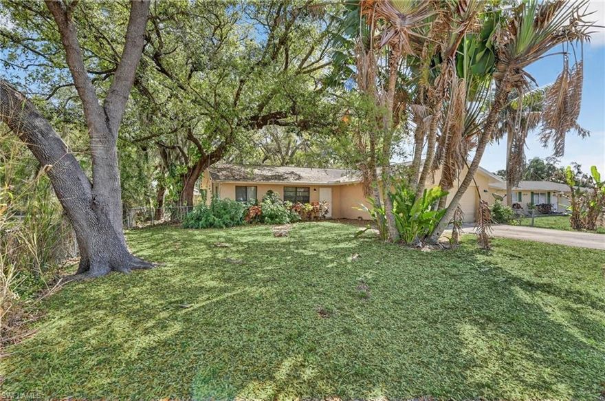This charming North Fort Myers River Bend subdivision home located at 1938 Flamingo Dr sits beneath grand oak tree canopies on a quiet residential cul-de-sac, yet it’s just minutes from grocery stores, shopping, restaurants, and centrally located between I-75 and US-41 for quick access in any direction. The open 2-bed, 2-bath layout features an updated kitchen with wood cabinetry, granite countertops, an island bar, stainless-steel appliances, and pendant lighting. The bathrooms are beautifully refreshed with granite vanity tops, pretty faucets, and tiled walls in the tub/shower areas, and the home offers all-tile flooring throughout—no carpet. A screened-in under-roof lanai with a convenient doggie door overlooks the fenced backyard with a side gate for rear access. An attached 2-car garage with a side entry door adds extra functionality and storage. Home include a 2015 Carrier Air Compressor and Air Handler in good condition, ductwork, a 3-Dimensional Asphalt Shingle.roof installed in 2015, a 2019 Hot Water Tank, Square D 200 AMP Electrical Panel, plus a new drainfield just two years ago. No HOA, across from waterfront homes and surrounded by Old-Florida oaks draped in sea moss, this centrally located property offers peace, flexibility, and character—you truly have to see it to believe it for the price! See linked tour and mapped location!