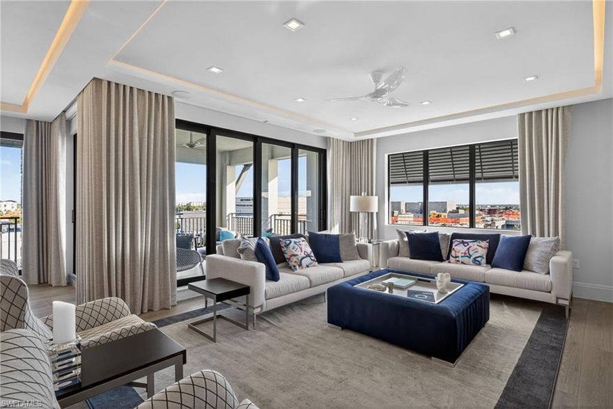 A rare northeast corner Penthouse featuring the Dover floor plan, set atop the 5th floor of Naples Square, delivers light-filled luxury, exceptional privacy, and the comfort and scale of a single-family home without the maintenance—all within a premier downtown lifestyle in Olde Naples. Acclaimed dining, coffee shops, cultural venues, and the white-sand shores of the Gulf of Mexico are within effortless reach. Adding to the exclusivity is a private, enclosed two-car garage, fully tiled and equipped with a refrigerator and rack storage. Inside, every detail has been thoughtfully curated. Extensive designer and engineering upgrades create a residence that is as technically sophisticated as it is visually striking. Italian Poliform cabinetry, furnishings, and closet systems are found in the bedrooms and den, offering cultured contemporary elegance and timeless craftsmanship, including his-and-her safes integrated into the custom primary closet system. Custom-designed ceilings with dramatic low-voltage LED cove lighting and linear slot diffusers add architectural distinction, while Control4 home automation seamlessly integrates lighting, audiovisual, and Ruckus WAPs systems. Surround sound enhances the living room, with additional built-in speakers in the primary bedroom, primary bathroom, kitchen, and lanai, creating a seamless audio experience throughout the home. A full alarm system provides added security and peace of mind. Premium features continue throughout, including Haiku ceiling fans, Somfy blackout electronic blinds, a whole-home Halo water filtration system and hot water recirculation pump, integrated dehumidifier, recessed Robern medicine cabinets, wine refrigeration, additional custom cabinetry, and Schlage electronic entry. The chef’s kitchen is outfitted with Bosch appliances, blending sleek modern design with exceptional performance, and features a statement island with pop-up 110V electrical receptacles and integrated USB ports. Resort-style amenities include a pool with ledge loungers, spa, an expansive pavilion with shaded communal dining and grilling areas, state-of-the-art fitness center, a well-appointed social room featuring a catering kitchen, and more. Low quarterly condo fees further enhance the appeal of this exceptional offering. Offered fully furnished, this penthouse sanctuary represents a rare convergence of luxury, location, and lifestyle at the very top of Olde Naples.