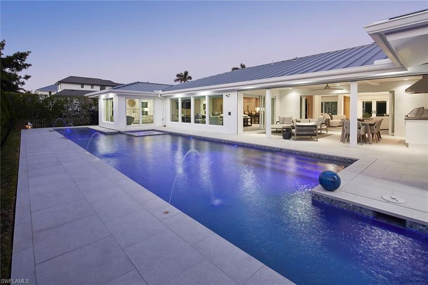 The finest of Neapolitan living awaits in this stunning residence, perfectly blending sophistication with practicality. No detail has been overlooked in this completely remastered and stylishly furnished home, with premium features including custom cabinetry, bespoke finishes, LED lighting, automated window coverings, built-in speakers, a generator and so much more. Stepping inside, you will be captivated by the flowing layout and exceptional craftsmanship throughout. The home’s two spacious living areas offer ample room for gathering, while the exquisite kitchen, with its premium oak cabinetry, custom quartz countertops and full suite of professional-grade appliances, stands ready to help you entertain in proper style. The owner’s suite is a true retreat, complete with a spa-inspired bath, two walk-in closets with built-ins, and an extravagant dressing closet that could act as your private boutique or double as a home office or gym. Across the home are two well-appointed guest bedrooms, each with its own en-suite bath, providing privacy and comfort. The ultimate highlight of this chic residence is its spectacular yard. Dive into luxury with an incredible pool and spa featuring a full swim lane, dine alfresco on the covered lanai with its summer kitchen, or gather around the radiant fire pit located in the spacious and private side courtyard. Residents of the neighborhood enjoy proximity to Park Shore's private beach access and beach path, The Village Shops on Venetian Bay and Waterside Shops.