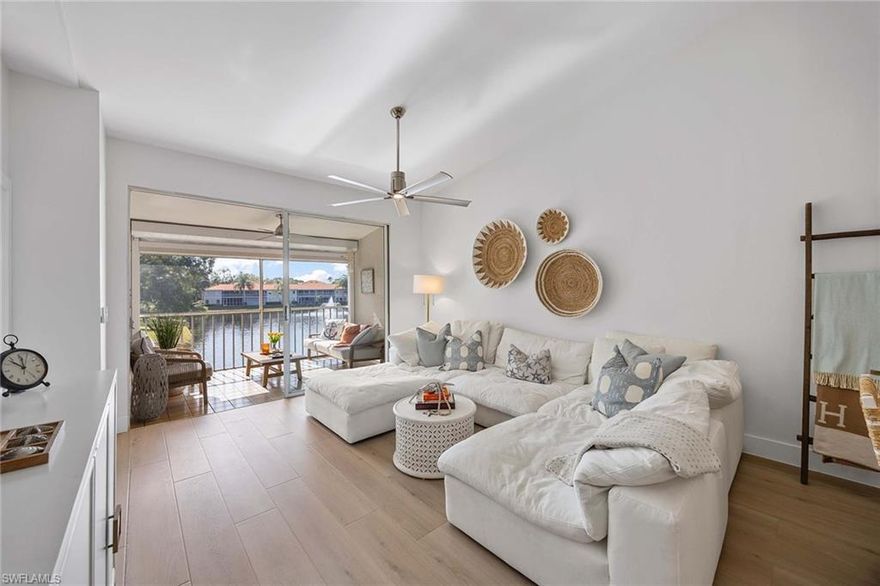 Newly remodeled and offered turnkey, this two-bedroom plus den, two-bath end-unit residence showcases a refined coastal design with modern upgrades throughout. Luxury vinyl flooring, new cabinetry, neutral paint throughout the home and elegant finishes elevates the open-concept layout. Expansive windows fill the interiors with natural light, complementing the residence’s airy ambiance. The kitchen features Taj Mahal quartz countertops and stainless-steel appliances ideal for daily living and entertaining. Plantation shutters provide a polished detail throughout. Enjoy serene views of the pond and illuminated fountains from your private lanai, all set within the lush, tropical surroundings of Pipers Grove, a gated community known for its vibrant lifestyle and resort-style amenities. Residents enjoy access to a renovated clubhouse and kitchen, resort-style pool, including a lap pool, bocce, tennis, fitness center and over two miles of scenic walking paths. Ideally just minutes from Vanderbilt Beach, award-winning schools, restaurants, boutique shopping and the stunning white sands of Southwest Florida's Gulf Coast. Walk to Publix, restaurants, shops and banks. With a private covered parking space and beautifully landscaped grounds, this residence offers a blend of comfort, convenience and coastal elegance, ideal as a year-round home or seasonal retreat.