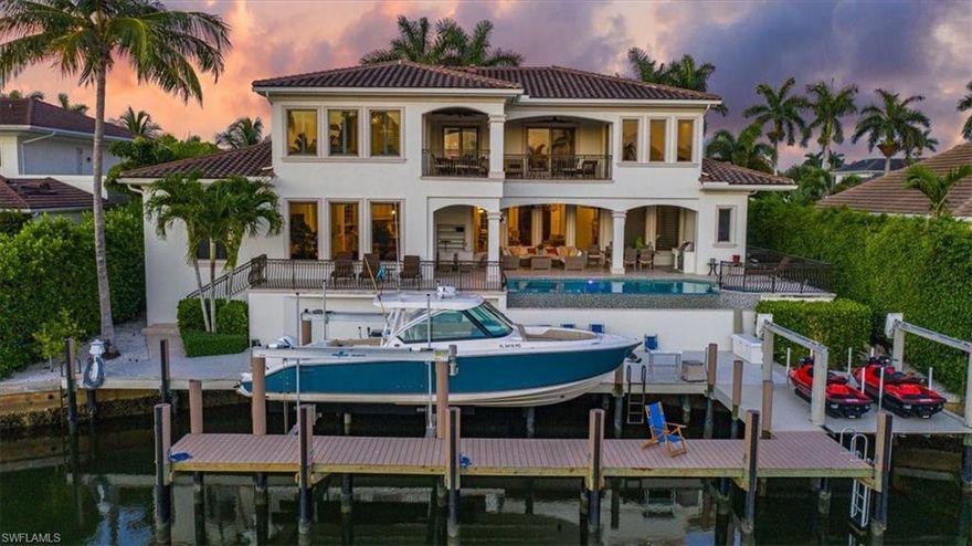 Stunning home on one of the widest canals in Aqualane Shores in Naples, Florida. Direct Gulf Access to Naples Bay. Walk to Third Street South and white sandy beaches. Enjoy bridge free boating with a new 24,000 lb boat lift and jet ski lifts. This meticulously kept home features 6540 square feet under air, an open floor plan, soaring ceilings, and a glorious outdoor living area on both levels. Enjoy a first-floor and top-floor master suite, Chef’s style kitchen, Wolf, Sub Zero and Bosch appliances, formal dining room and breakfast bar, living room with a fireplace, family room, laundry rooms on both floors, marble and wood flooring throughout.  4 car garage, bonus room and private elevator. Spacious lanai with automatic screens and outdoor kitchen area. Home features western exposure with breathtaking sunsets waiting to be seen from the striking infinity edge saltwater pool & spa. Come enjoy the sunshine year round!