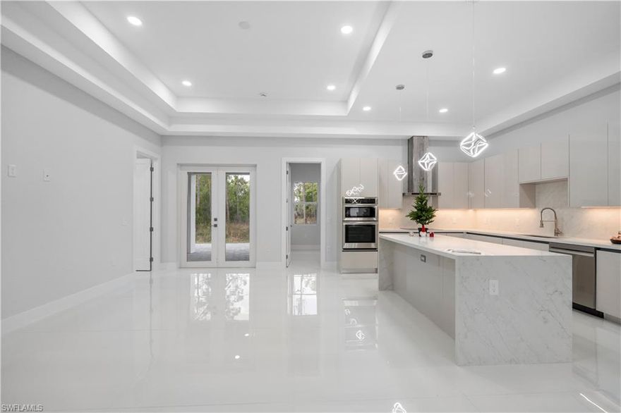 READY TO MOVE IN!
Step into modern Florida living with this newly built, thoughtfully designed 4-bedroom, 3-bath residence in the highly desirable Golden Gate Estates. Situated on a 100% upland lot, this property offers complete land use with no HOA and no restrictions, giving you the freedom to truly make it your own. A brand-new fence is already in place, providing privacy and security without sacrificing space.

This home offers 1,775 sq. ft. of living area under air and nearly 3,000 sq. ft. total under roof, showcasing quality craftsmanship and refined finishes throughout. Enjoy soaring ceilings, impact-resistant windows and doors, and stunning 48” x 48” imported porcelain tile flooring that adds a sleek, contemporary feel.

The gourmet kitchen is designed to impress, featuring quartz countertops, a dramatic waterfall island, soft-close cabinetry, and premium stainless-steel appliances—perfect for both entertaining and everyday living. Each bedroom includes custom-built closets, blending style with functionality.

Step outside to an expansive extended patio with a built-in outdoor kitchen, ideal for hosting gatherings and enjoying beautiful Florida sunsets. Additional highlights include an oversized paver driveway, modern designer lighting, and a whole-home reverse osmosis water system. The spacious lot offers plenty of room for a pool, guest house, or additional outdoor amenities. Conveniently located in a peaceful setting while just minutes from Naples shopping, top-rated schools, and world-class beaches. This home also includes a home warranty, so you can move in with confidence!