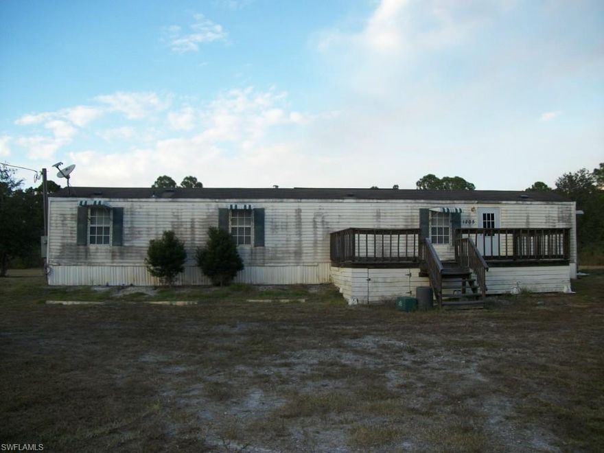 2005 Single wide with screened in porch, located on 2.5 acres. Home needs AC and pressure cleaning. Property is fenced and cross fenced with horse stalls and chicken pens.